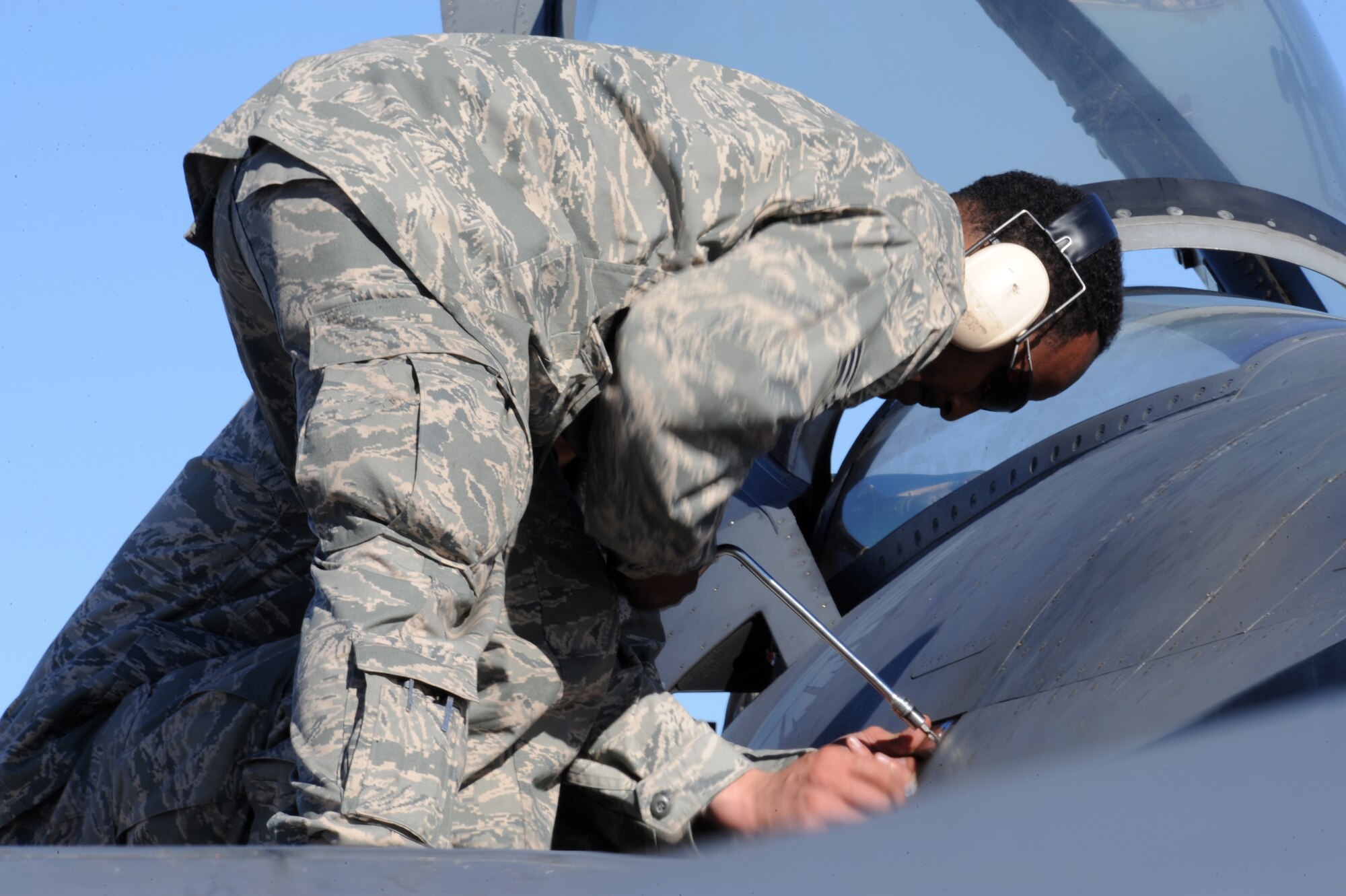 NELLIS AIR FORCE BASE, Nev. -- Senior Airman Teferi Gebretsadik, an electrical and environmental journeyman assigned to the 22nd Aircraft Maintenance Unit at Spangdahlem Air Base, Germany, screws together a panel on a F-16 Fighting Falcon during Red Flag 09-2 at Nellis Air Force Base, Nev., Jan. 30. (U.S. Air Force photo/Senior Airman Larry E. Reid Jr.)