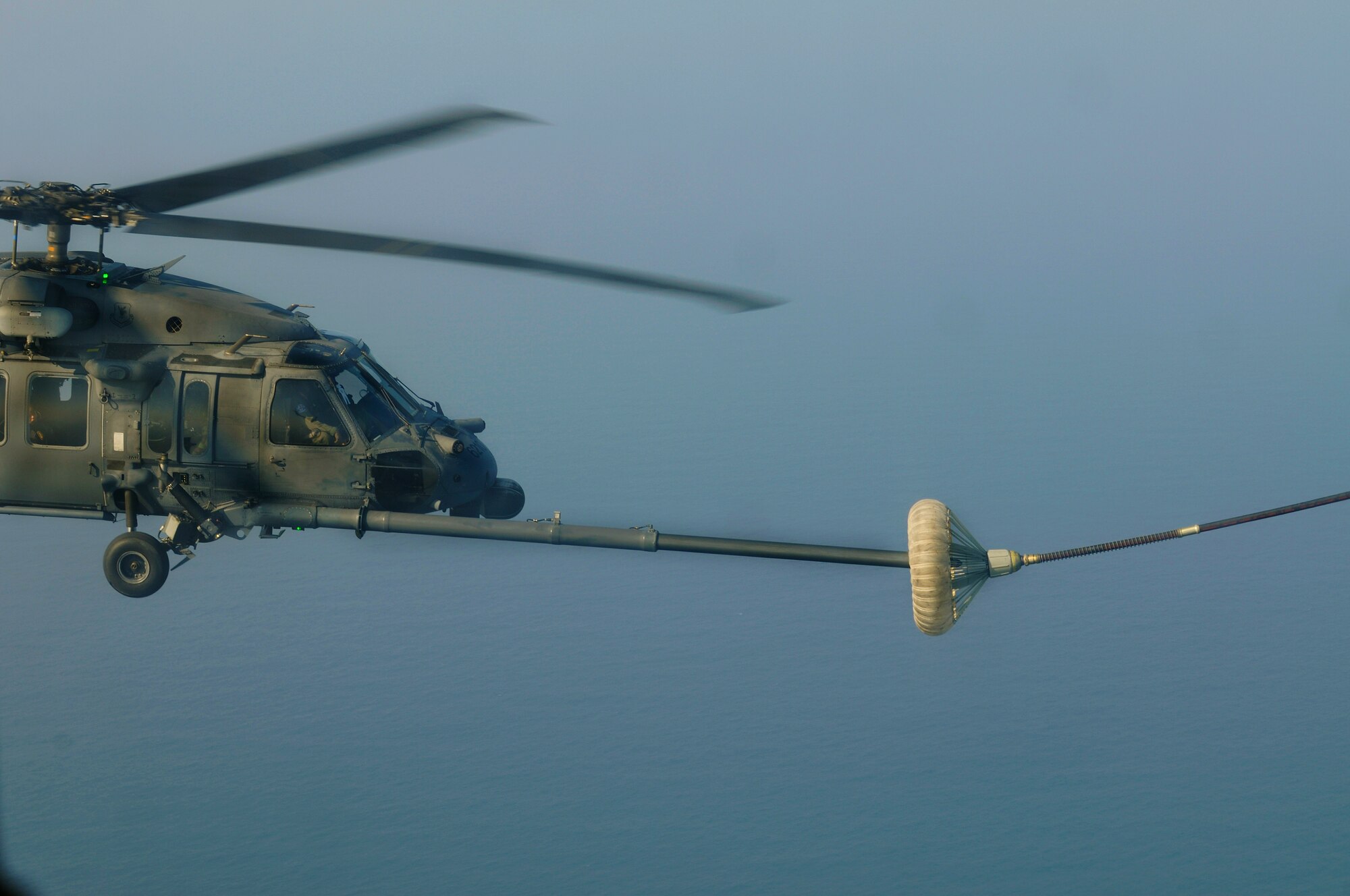 An HH-60 Pave Hawk prepares to receive fuel from an HC-130 during a flight off the Coast of Okinawa, Japan as part of exercise Cope Angel 09-1. Cope Angel is a joint rescue exercise between members of the U.S. Air Force and the Japanese Air Self Defense Force. (U.S. Air Force photo/Airman 1st Class Chad Warren)