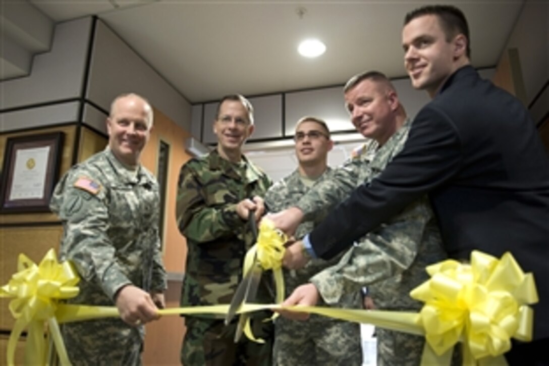 From left to right, U.S. Army Brig. Gen. Kevin Magnum, commander, 10th Mountain Division Rear; U.S. Navy Adm. Mike Mullen, chairman of the Joint Chiefs of Staff; Pvt. Jacob Biss; Col. Jerry Penner, commander, U.S. Army Medical Department Activity; and Dr. Todd Benham, chief, Behavioral Health, participate in a ribbon-cutting ceremony for the new Behavioral Health Clinic on Fort Drum, N.Y., Feb. 9, 2009.