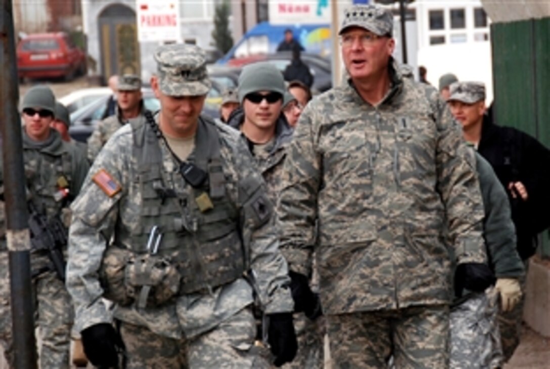 Air Force Gen. Craig R. McKinley, chief of the National Guard Bureau, right, and Army Capt. Shannon Dean Holiday, commander for Multi-National Task Force East, Thunder Bravo battery, walk the streets of downtown Pristina, Kosovo, Feb. 7, 2009, during a presence patrol with the Missouri Army National Guard. The Guard soldiers patrol one of the more populated areas of the American NATO peacekeeping missions in Kosovo. 