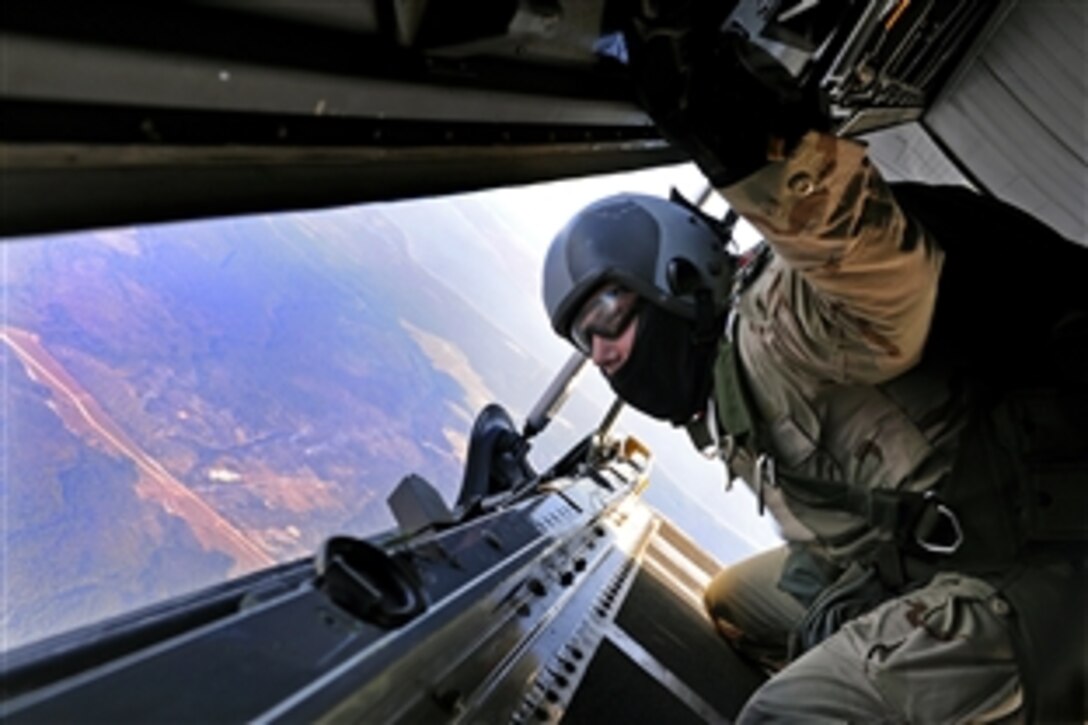 A U.S. Air Force special operator peers out from a C-130 ramp to identify the drop zone before a high altitude low opening jump during the Emerald Warrior Exercise, Hurlburt Field, Fla., Feb. 4, 2009.