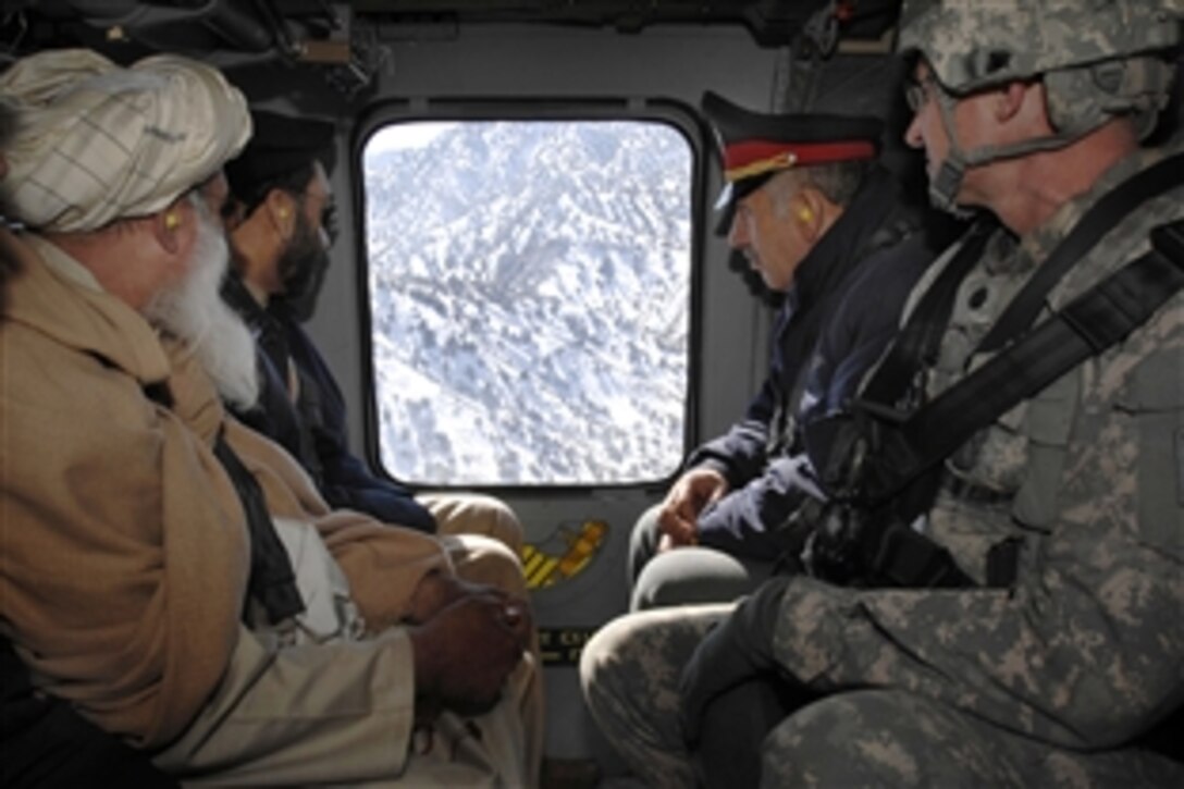 U.S. Air Force Lt. Col. Dan Moy, far right, commander for Afghanistan's Paktia Provincial Reconstruction Team, travels by Black Hawk helicopter to a remote combat outpost with the provincial governor, police chief and a religious leader for a meeting with district leaders Feb. 8, 2009. The team works to get government leaders out to rural districts.