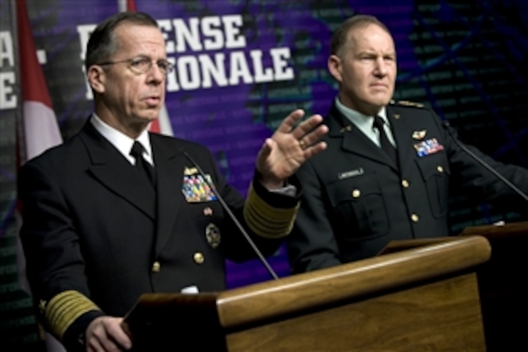 U.S. Navy Adm. Mike Mullen, chairman of the Joint Chiefs of Staff, and Army Gen. Walt Natynczyk, Canadian chief of Defense, address the media during a joint press availability in Ottawa, Canada, Feb. 10, 2009. 