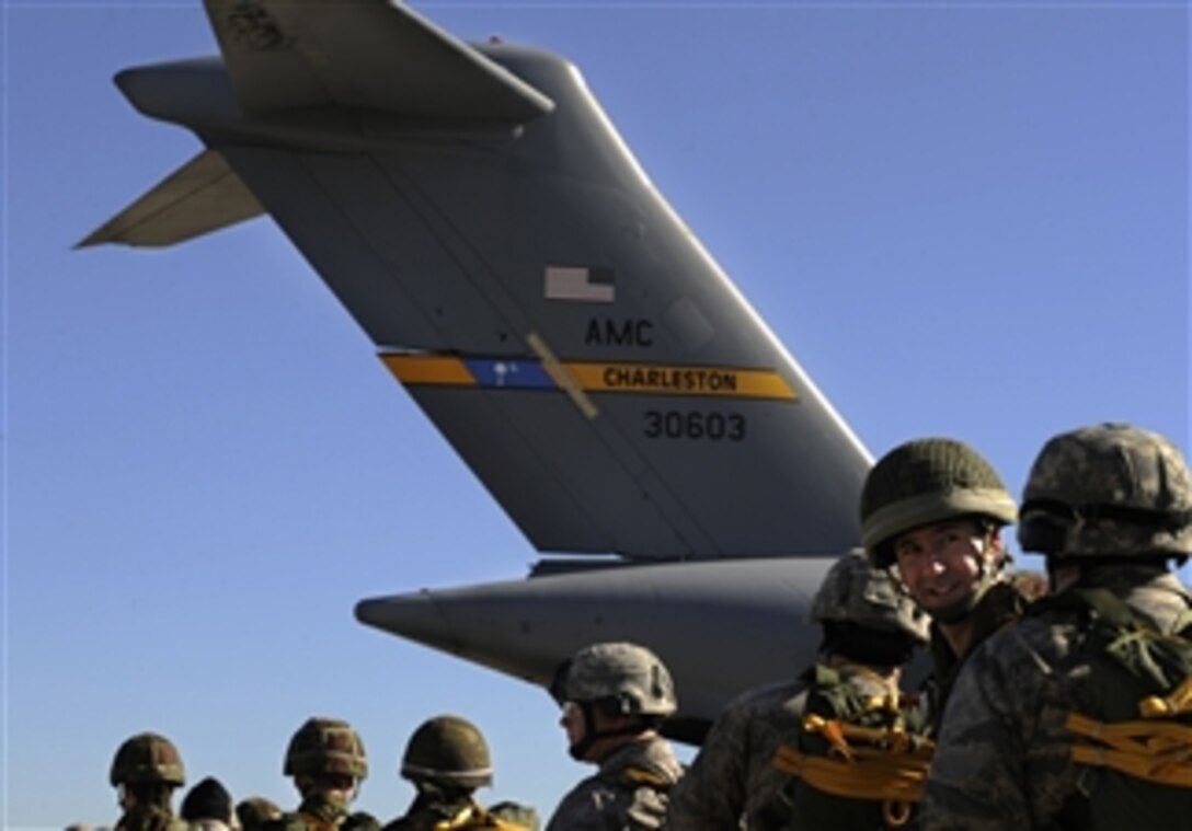 U.S. Air Force airmen from the 820th Security Forces Group and personnel from the II Squadron Royal Air Force Regiment, from Royal Air Force Honington, wait to board a C-17 Globemaster III aircraft to perform a static line parachute jump over Moody Air Force Base, Ga., on Feb. 5, 2009.  The Royal Air Force members are visiting the 820th Security Forces Group for a training exercise called Operation Winged Eagle.  