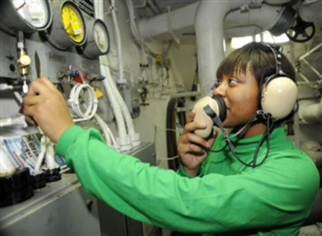 U.S. Navy Petty Officer 3rd Class Jennifer Nwokedi reports the water level of the catapult brakes to the panel operator aboard the aircraft carrier USS Theodore Roosevelt (CVN 71) underway in the Gulf of Oman on Feb. 7, 2009.  The ship and embarked Carrier Air Wing 8 are operating in the U.S. 5th Fleet area of responsibility.  