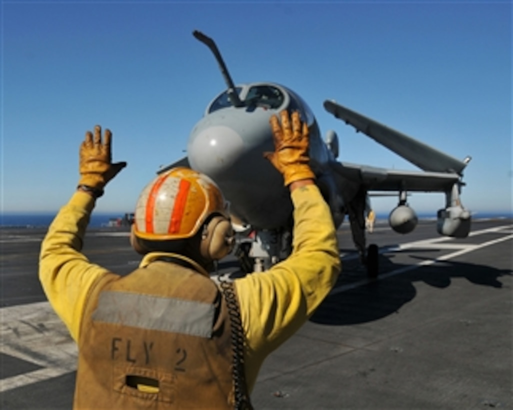A U.S. Navy EA-6B Prowler aircraft assigned to Electronic Attack Squadron 131 is guided into position following its return to the flight deck of the aircraft carrier USS Abraham Lincoln (CVN 72) on Feb. 2, 2009.  The aircraft was participating in an aerial change of command ceremony while the ship is underway in the Pacific Ocean.  