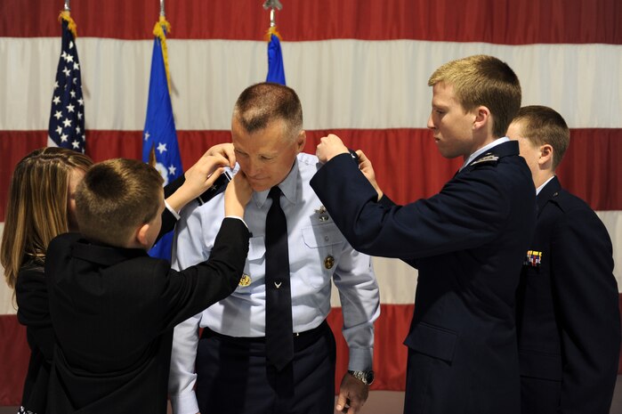 U.S. Air Force Warfare Center vice commander, Brig. Gen. Kevin McLaughlin, gets his first star pinned on by his children: Meredith, Bryson, Andrew and William at the Thunderbird hangar Feb. 6. The USAFWC exists to provide well-trained and equipped combat forces ready for deployment to conduct integrated combat operations.(U.S. Air Force photo by Airman 1st Class Brett Clashman)
