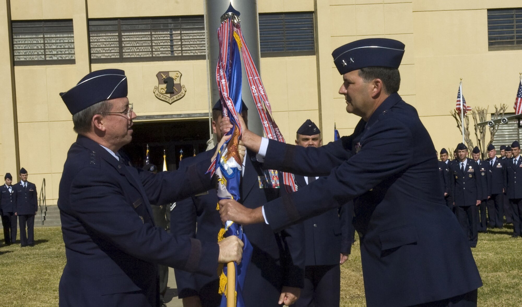 Lt. Gen. David A. Deptula (left), deputy chief of staff for intelligence, surveillance and reconnaissance at the Pentagon, passes the guidon to Maj. Gen. Bradley A. Heithold during the Air Force ISR Agency change of command ceremony held Feb. 11 at Lackland Air Force Base, Texas. (U.S. Air Force photo/Ted Koniares)