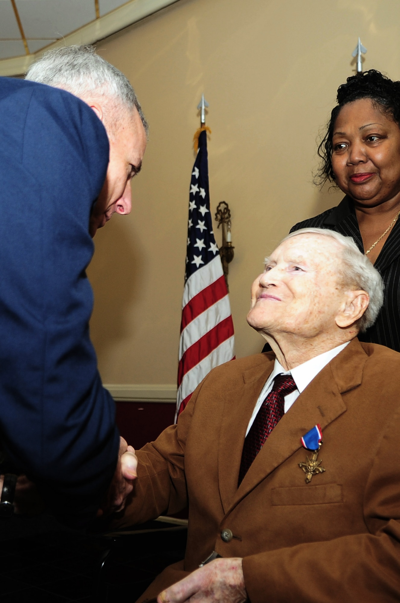 Maj. Gen. Floyd Carpenter, vice commander of 8th Air Force, shakes the hand of Walter T. Holmes Feb. 2 after presenting him with the second-highest military award, the Distinguished Service Cross. The award is being presented 65 years after Mr. Holmes and his fellow B-24 pilots performed low-level bombing missions over the Ploesti oil refineries in Rumania during World War II.  (U.S. Air Force photo/Senior Airman Joanna M. Kresge)