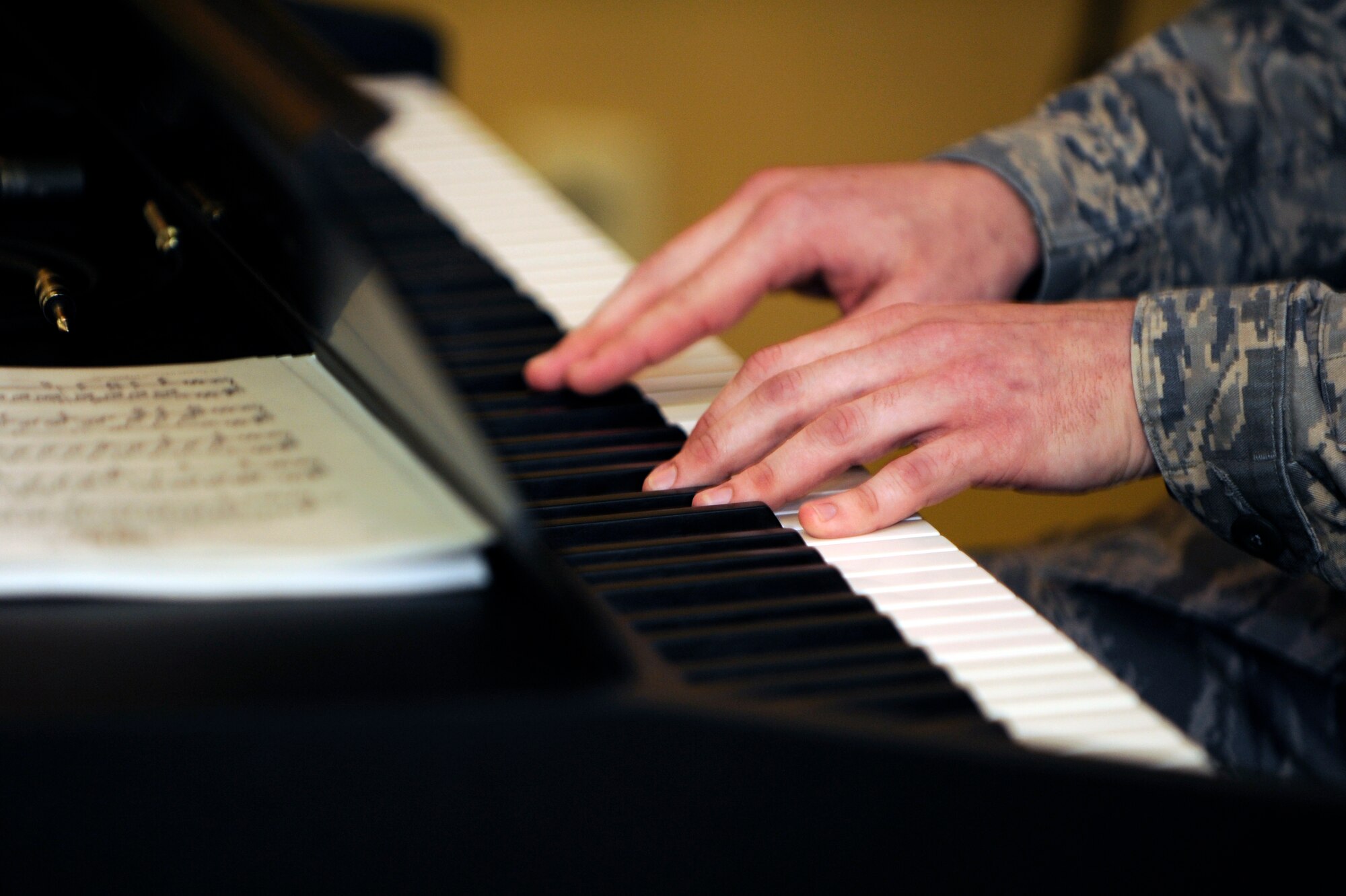 Staff Sgt. Shaun Jansen, 28th Bomb Wing chaplain assistant, plays "America the Beautiful" during the National Prayer Luncheon here Feb. 10.  The luncheon featured guest speaker Chaplain (Brig. Gen.) David Cyr, Air Force Deputy Chief of Chaplains. (U.S. Air Force photo/Airman 1st Class Matthew Flynn)