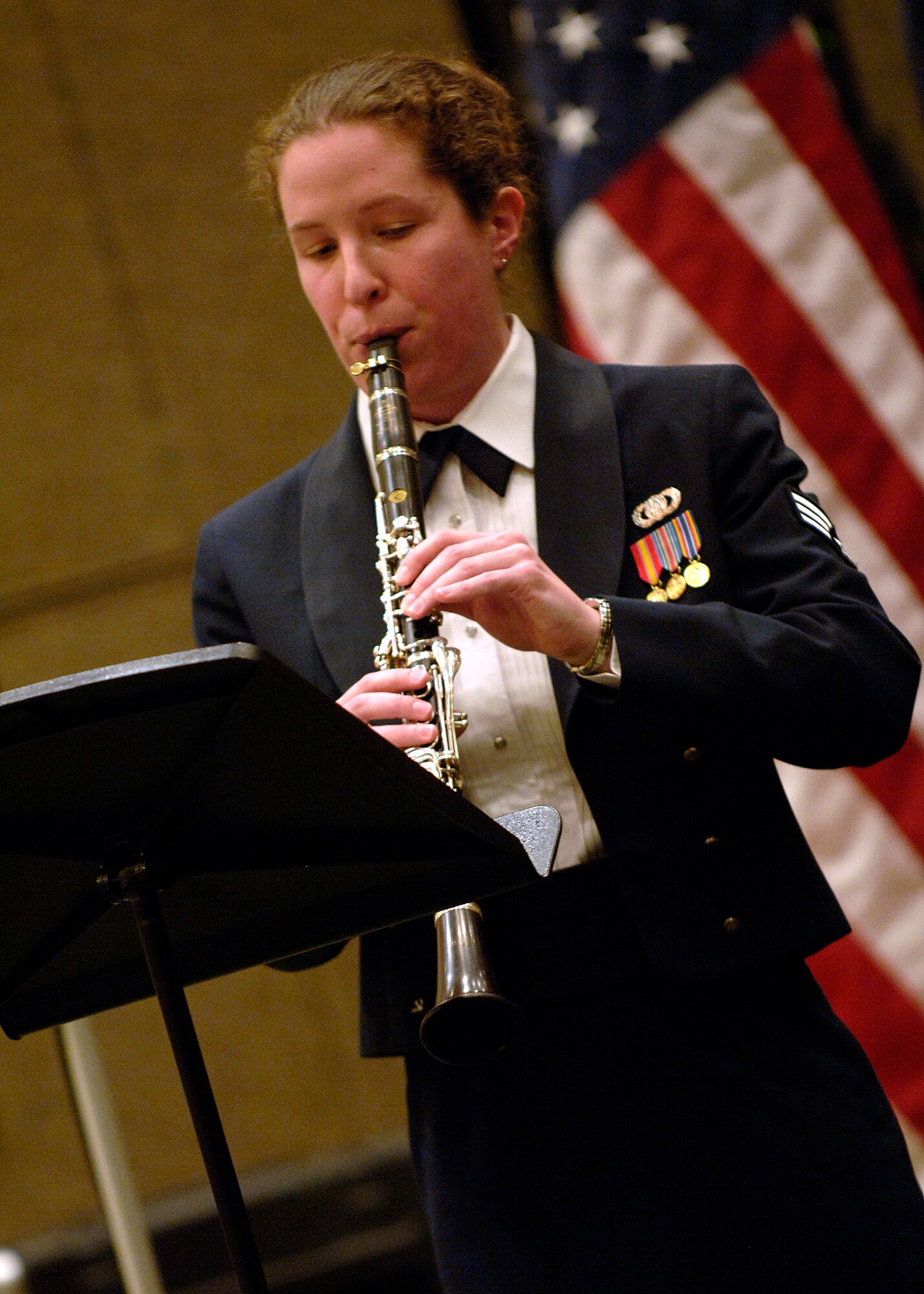 Senior Airman Amy McCann performs a solo during the song Desert Roads by David Maslanka at the Charleston Coliseum Feb. 6. The Heritage of America Band is comprised of 47 professional active-duty musicians who perform for more than 1 million people each year in venues from formal, informal and even Major League Baseball and NASCAR. Airman McCann is with the Air Force Heritage of America Band. (U.S. Air Force photo/Senior Airman Timothy Taylor)

