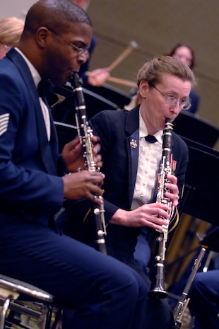 Tech. Sgt. Joshua Gates and Tech. Sgt. Amy Lynch play the clarinet during a live performance at the Charleston Coliseum Feb. 6. The Heritage of America Band is comprised of 47 professional active-duty musicians who perform for more than 1 million people each year in venues from formal, informal and even Major League Baseball and NASCAR.  Sergeant Gates and Sergeant Lynch are both with the Air Force Heritage of America Band. (U.S. Air Force photo/Senior Airman Timothy Taylor)