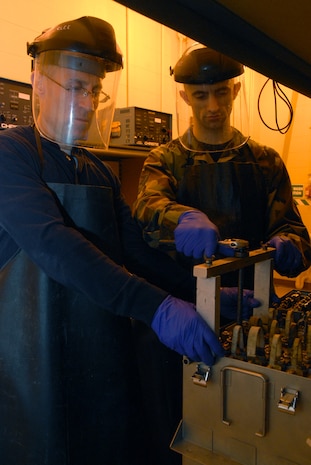 Master Sgt. Michael Bunting and Senior Airman David Stricker work together on removing a cell from an aircraft battery at the 437th Maintenance Squadron Electrical and Environmental Battery Shop Feb. 11. The ELEN battery shop is responsible for maintaining all the C-17 batteries for Charleston AFB. Sergeant Bunting is an electrical and environmental systems craftsman for the 315th Maintenance Squadron and Airman Stricker is an electrical and environmental systems journeyman for the 437 MXS. (U.S. Air Force photo/Airman Ian Hoachlander)