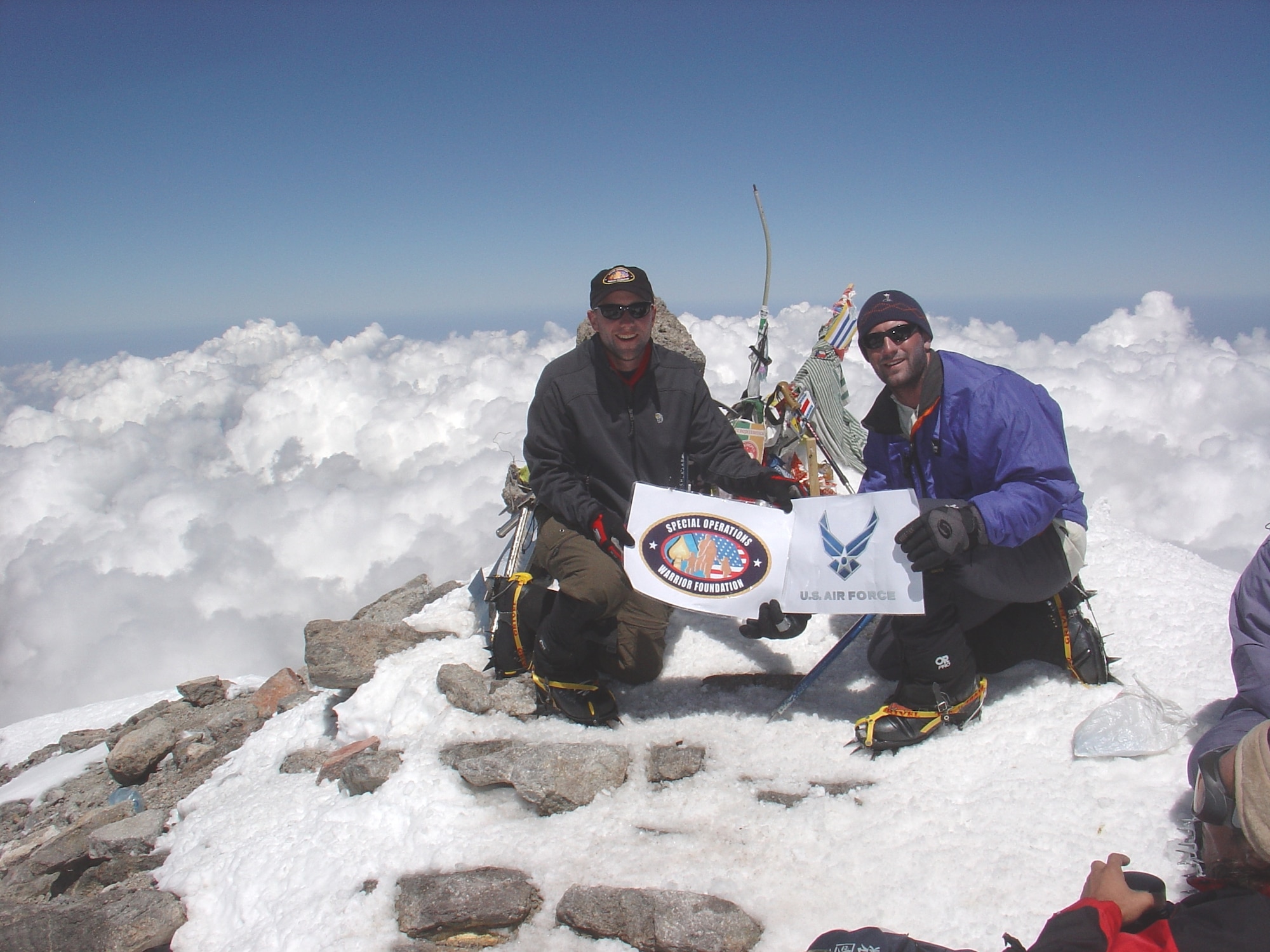 Capt. Rob Marshall, 8th Special Operations Squadron, and then 1st Lt. Mark Uberuaga, 55th Rescue Squadron, display the Air Force and Special Operations Warrior Foundation logos at the summit of Russia’s Mount Elbrus in July 2005. The Airmen founded the U.S. Air Force Seven Summits Challenge, which aims to lead a team of Air Force members to the top of the highest mountain on each continent. Mount Elbrus, the tallest peak in Europe at 18,510 ft., was the group’s inaugural climb. (U.S. Air Force photo)