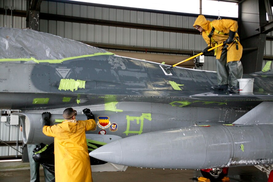 SHAW AIR FORCE BASE, S.C.-- Capt. Scott Hall, 20th Maintenance Operations Squadron and Capt. Joshua Wennrich, 20th Aircraft Maintenance Squadron, scrub down an F-16 in the Wash Rack Feb. 10. Six maintenance group CGOs and four Airmen spent about three hours washing the F-16. The F-16s are washed every 60 days to keep them mission-ready. (U.S. Air Force photo/SSgt Holly Brown)