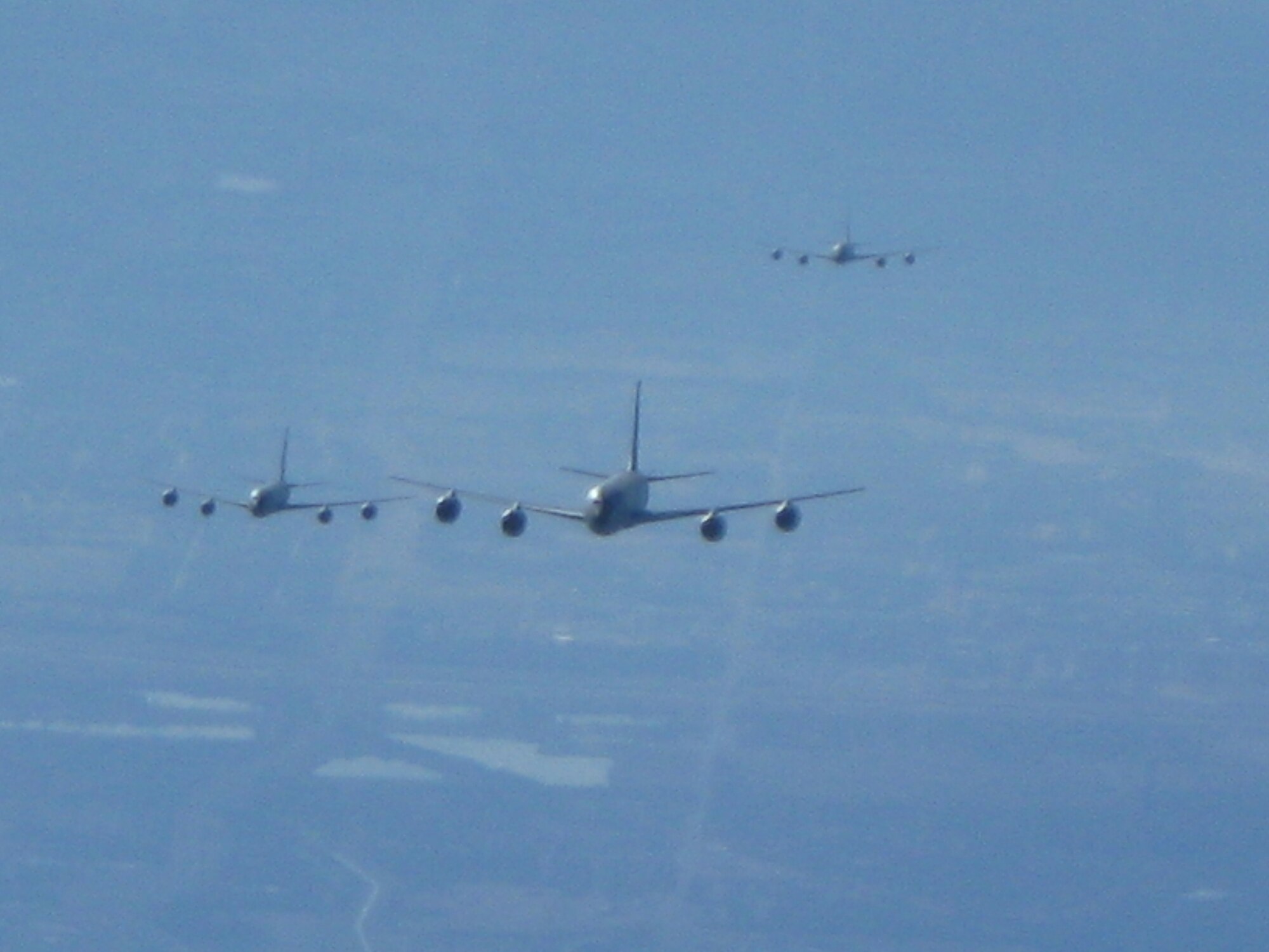 Three KC-135 Stratotankers can be seen out the back window of another KC-135 after all four jets took off from McConnell Air Force Base, Kan., on Feb. 7. The rare four-ship formation was designed to enhance training with KC-135s capable of receiving fuel, a capability only found with tankers assigned to McConnell AFB. (U.S. Air Force photo/Staff Sgt. Jay Guldjord) 