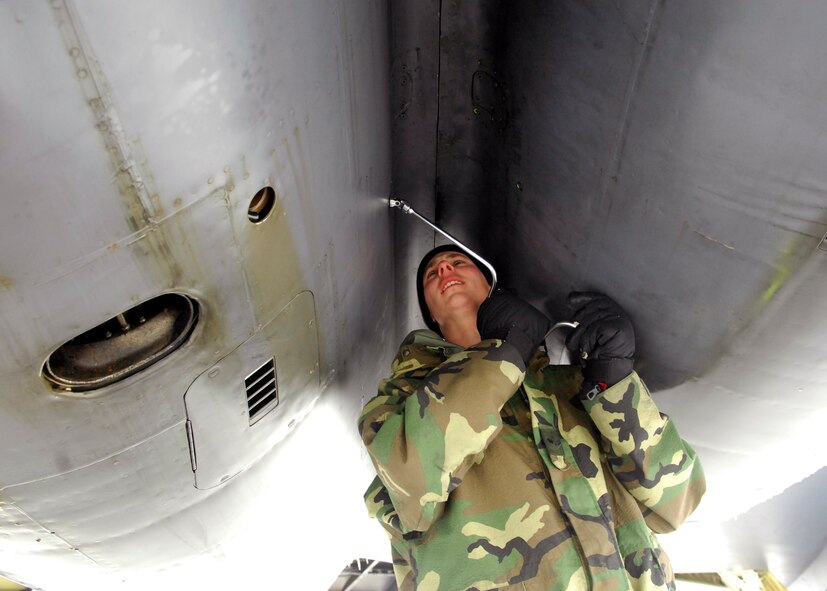 MINOT AIR FORCE BASE, N.D. -- Senior Airman Rodney Marshall, a jet engine mechanic in the 5th Aircraft Maintenance Squadron, works on the cowling of a B-52H Stratofortress here Feb 11.  Airman Marshall, a native of Franklin, Georgia, has been assigned to the 5th AMXS for three years and said it took him at least a year to become acclimatized to North Dakota weather. (U.S. photo by Staff Sgt. Keith Ballard)