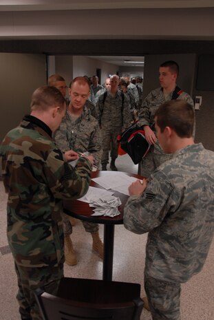 Senior Airmen Joshua Bounds, left, and Clinton Packwood, right, check in Airmen Feb. 7 in the 437th Aerial Port Squadron Passenger Terminal for a contracted aircraft that will take them to Southwest Asia in support of Operations Enduring and Iraqi Freedom.  More than 800 Airmen from various installations throughout the Air Force have been coming to Charleston AFB since Dec. 22, 2008 to be deployed. The base is one of five aerial ports of embarkation that makes it more convenient for Airmen to deploy to the area of responsibility. Airmen Bounds and Packwood are passenger service representatives with the 437 APS. (U.S. Air Force photo/Staff Sgt. Jennifer Arredondo)