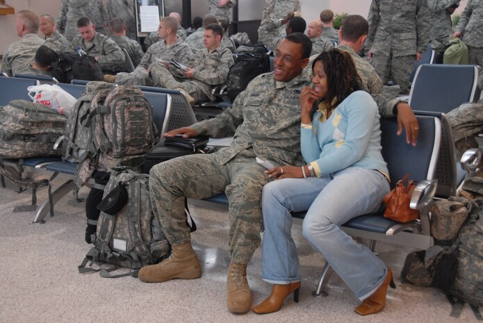 Capt. Christopher Simmons and his wife, Tasha, wait together in the 437th Aerial Port Squadron Passenger Terminal here Feb. 7 until it is time for him  to board the aircraft that will take him to his deployed location.  More than 800 Airmen from various installations throughout the Air Force have been coming to Charleston AFB since Dec. 22, 2008 to be deployed.  The base is one of five aerial ports of embarkation that makes it more convenient for Airmen to deploy to the area of responsibility. Captain Simmons is with the 52nd Logistics Readiness Squadron, Spangdahlem AB, Germany. (U.S. Air Force photo/Staff Sgt. Jennifer Arredondo)