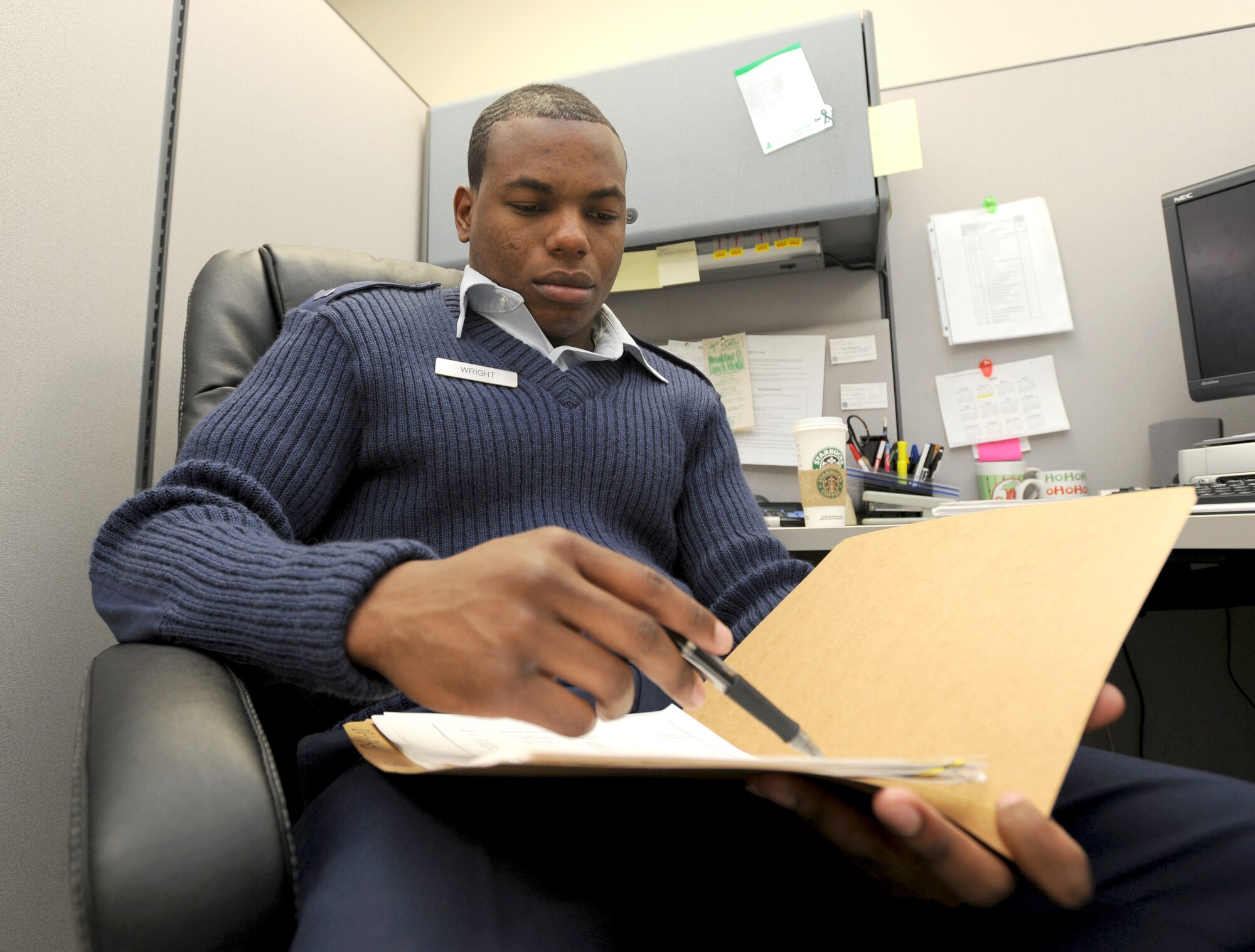 MCCONNELL AIR FORCE BASE, Kan. -- Senior Airman Tajsean Wright, 22nd Medical Support Squadron, reviews Medical Affirmative Claims paper work at the base clinic, Feb 9. The MAC program identifies and recovers the cost of medical and dental care provided for injuries or diseases caused under circumstances due to a wrongful act, damage, or injury where compensation is covered by a liable third party   (Photo by Senior Airman Roy Lynch) 