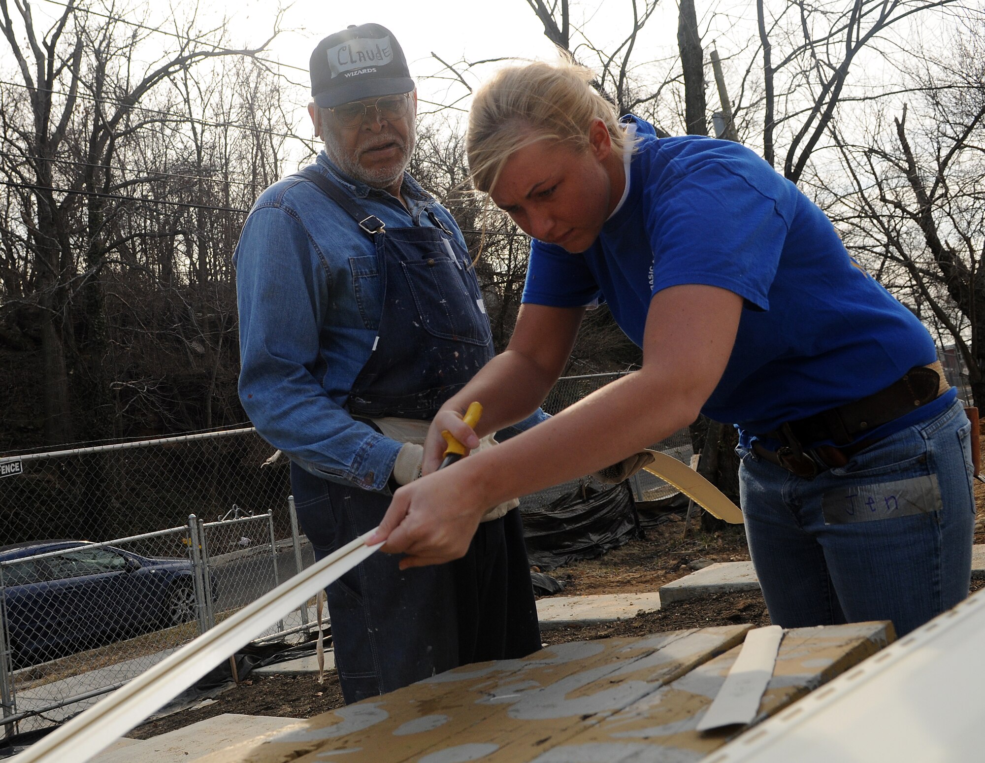 Airman 1st Class Jennifer Corbin, United States Air Force Honor Guard, assists Claude W. Brame Feb. 11 during a Habitat for Humanity project in Washington D.C. The 16 Bolling volunteers worked side-by-side with trained crew members to accomplish various tasks throughout the day. (U.S. Air Force photo by Senior Airman R. Michael Longoria)