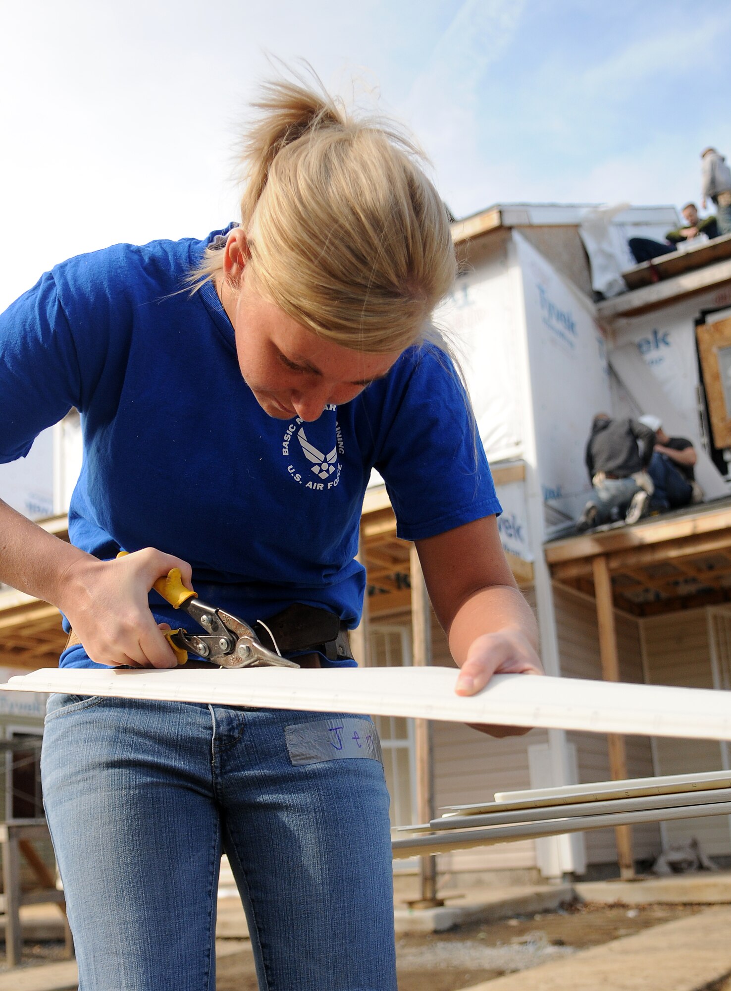 Airman 1st Class Jennifer Corbin, United States Air Force Honor Guard, trims a piece of siding Feb. 11 during a Habitat for Humanity project in Washington D.C. The 16 Bolling volunteers worked side-by-side with trained crew members to accomplish various tasks throughout the day. (U.S. Air Force photo by Senior Airman R. Michael Longoria)