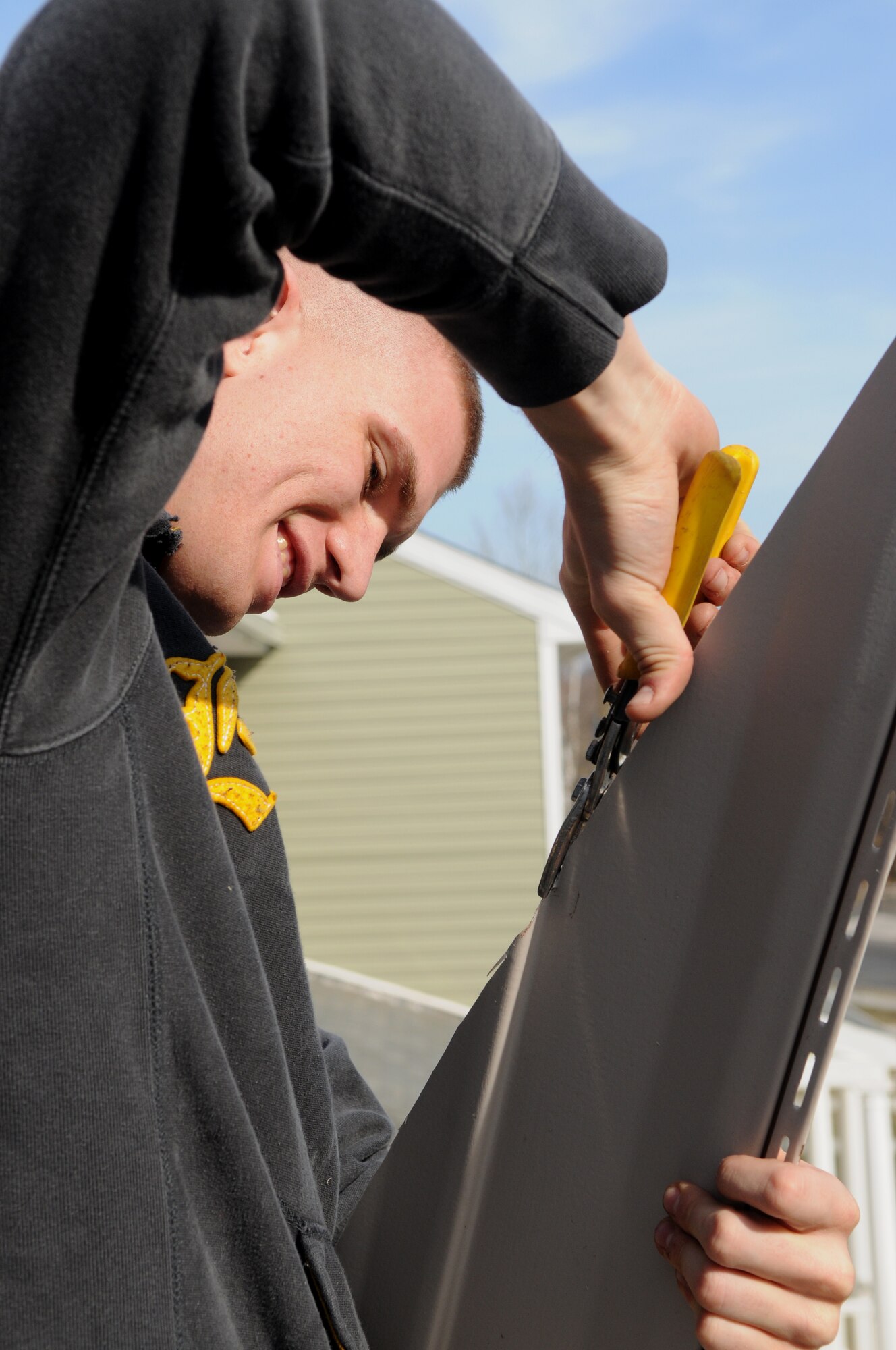 Senior Airman Zack Ritsema, United States Air Force Honor Guard, cuts a piece of siding Feb. 11 during a Habitat for Humanity project in Washington D.C. The 16 Bolling volunteers worked side-by-side with trained crew members to accomplish various tasks throughout the day. (U.S. Air Force photo by Senior Airman Marleah Miller)