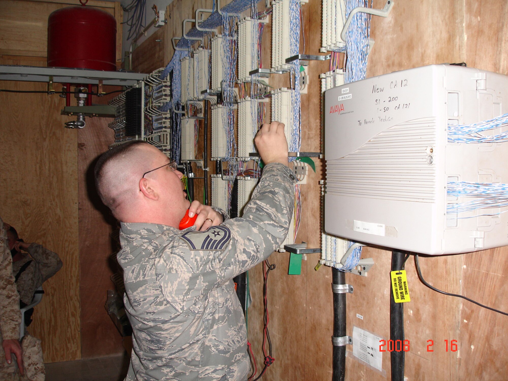 Master Sgt. James Preston, NCO in charge of telephone systems for the 55th Combat Communications Squadron, troubleshoots phone lines in a communications closet at a deployed location. Courtesy photo 