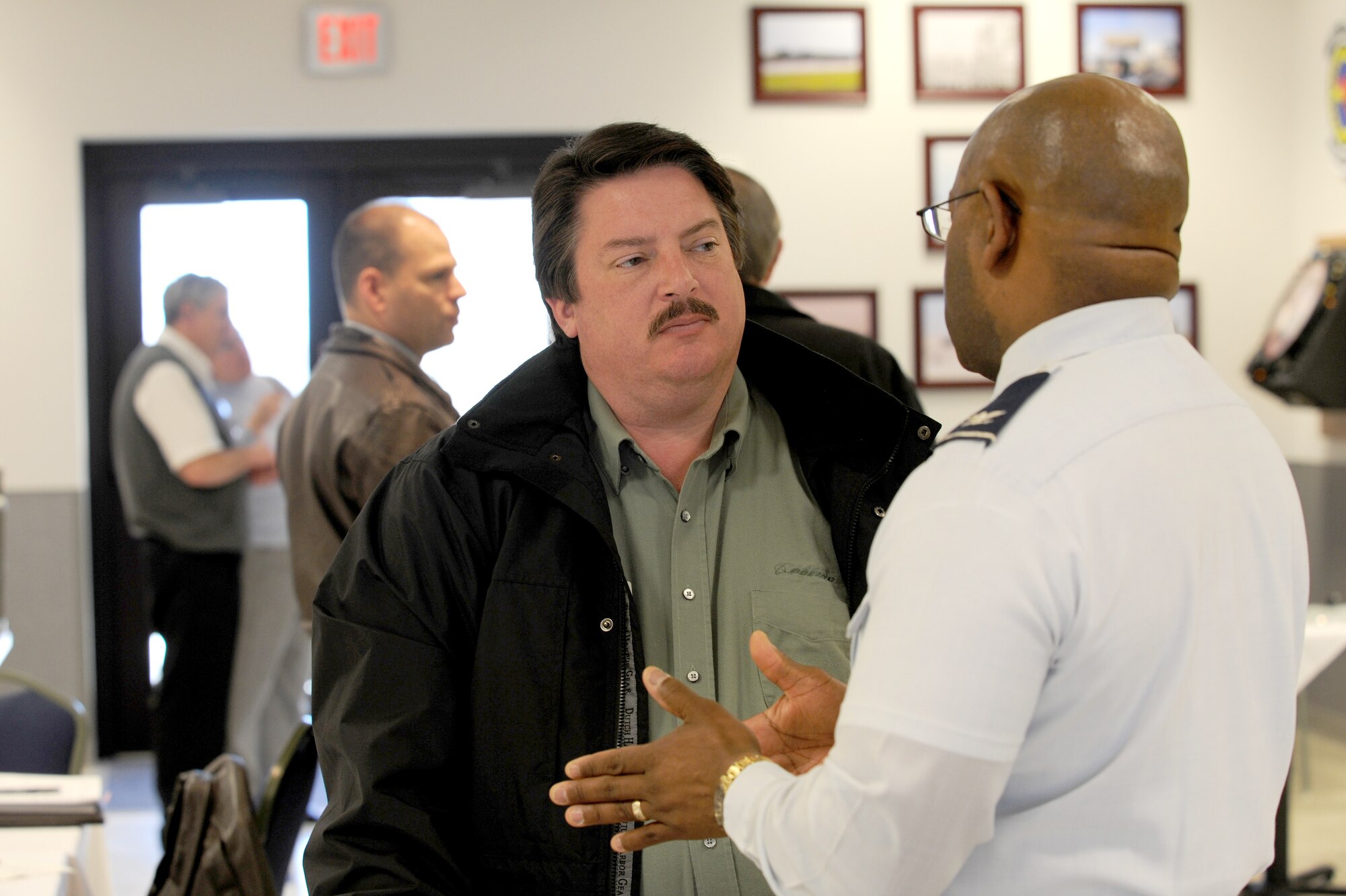 MCCONNELL AIR FORCE BASE, Kan. -- Eric Fischer, 22nd Maintenance Group honorary commander, listens to Col. Michael Dillard, 22nd Maintenance Group commander during a Civic Leader Luncheon at the 184th Jayhawk Roost dining facility, Feb 9.   (Photo by Senior Airman Roy Lynch) 