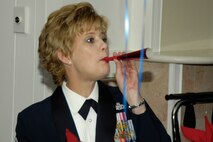 HANSCOM AIR FORCE BASE, Mass. – Chief Master Sgt. Ginger Thompson, 66th Medical Group superintendent, makes some noise as she cheers on the nominees at the 66th Air Base Wing Annual Awards banquet that took place at the Minuteman Club on Feb. 6. (U.S. Air Force photo by Linda LaBonte Britt)