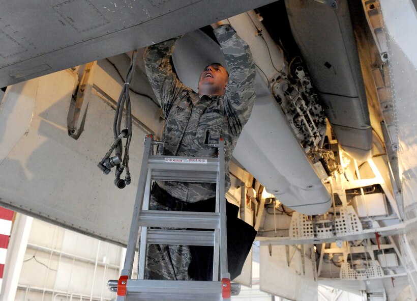 DYESS AIR FORCE BASE, Texas -- Technical Sgt. Thomas Perry checks cables inside of the B-1 training module during the Giant Sword II weapons loading competition here, Feb. 9. Sergeant Perry was team leader during the competition and helped the load team successfully execute the load in 22 minutes.  (U.S. Air Force photo by Senior Airman Domonique Simmons)