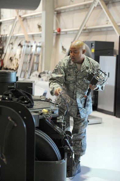 DYESS AIR FORCE BASE, Texas -- Staff Sgt. Teddy Miro operates a trailer used for carrying weapons to be loaded inside a B-1B Lancer's weapons bay during the Giant Sword II weapons loading competition here, Feb. 9. Sergeant Miro's tasks were part of a team effort in this timed inspection. The team representing the 7th Bomb Wing completed the load in 22 minutes. (U.S. Air Force photo by Senior Airman Domonique Simmons)