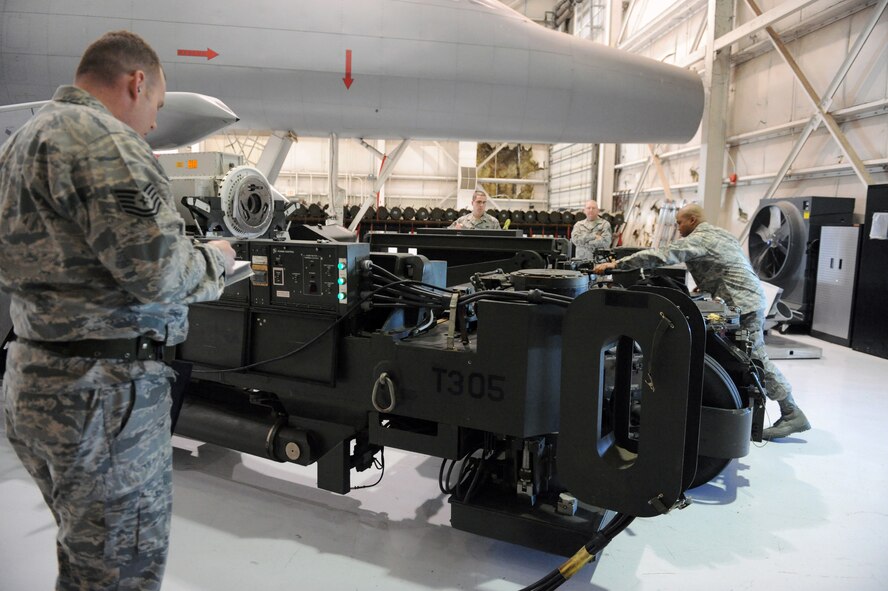 DYESS AIR FORCE BASE, Texas -- The 7th Bomb Wing load crew team performs checks and loads  weapons onto a B-1 training model during a timed competition here, Feb. 9. 8th Air Force inspectors evaluated their performance and procedure and will compare the results with other bomber wings across the Air Force. (U.S. Air Force photo by Domonique Simmons)