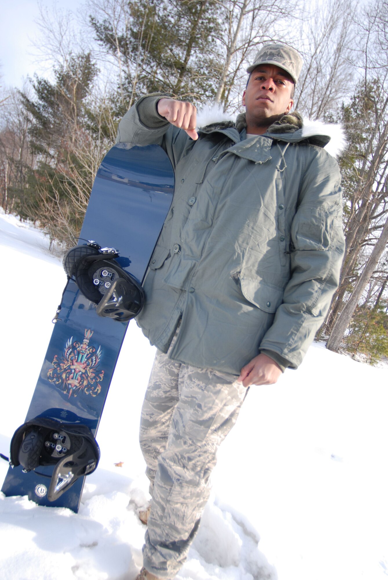 Senior Airman Joseph Hill, network services technician, 103rd Communications Squadron, shows off his trusty snowboard February 5, 2009.  (U.S. Air Force Photo by Staff Sgt. Erin McNamara)