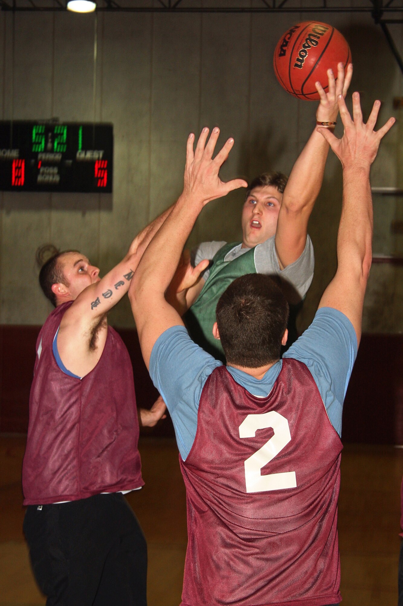 GRISSOM AIR RESERVE BASE, Ind.-- Joseph 'Joey' S. Cougan, Jr., rockets a shot over Gabriel Rienks, left, and another player from the 434th Seasoning Flight team as he tries to take his team to the championship game. Cougan is the son of Joseph S. Cougan, Sr., who also plays on his team made up of men from the 434th Civil Engineer Squadron's fire department. Cougan's brother, Jake also played for the boys in green. Despite the Cougan family's best efforts, the group from the 434th Services Squadron took home the championship. (U.S. Air Force photo/Staff Sgt. Mark Orders-Woempner)