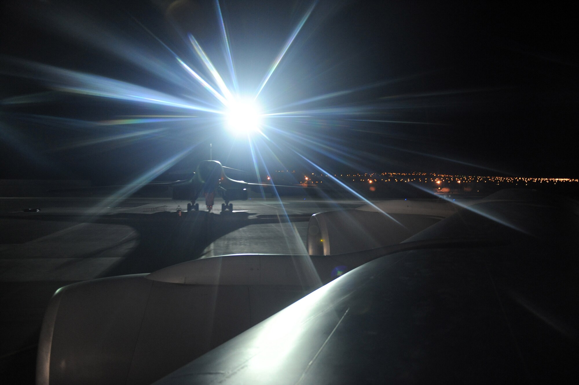 A B-1B Lancer can be seen over the wing of a KC-135 Stratotanker Feb. 3 prior to a night refueling mission during a Red Flag exercise at Nellis Air Force Base, Nev.  Red Flag is a multi-national exercise providing a realistic environment to practice combat scenarios.  The experience gained during the exercise is vital to the survival of air crews in combat.  (U.S. Air Force photo/Senior Airman Nadine Y. Barclay)