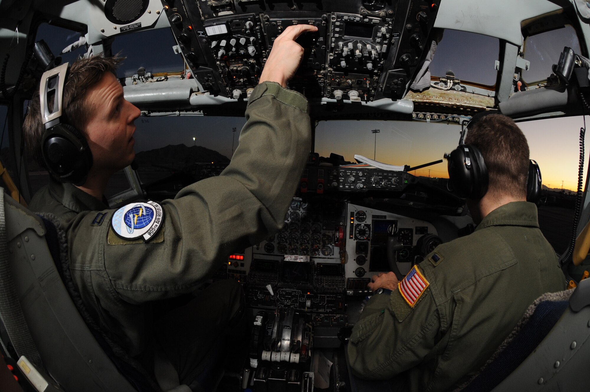 Capt. Jason Merrill (left) and 1st Lt. Joshua Rope perform a pre-flight inspection Feb. 3 in the cockpit of a KC-135 Stratotanker during a Red Flag exercise at Nellis Air Force Base, Nev.  Red Flag is a multi-national exercise providing a realistic environment to practice combat scenarios.  The experience gained during the exercise is vital to the survival of air crews in combat.  The two pilots are from the 905th Air Refueling Squadron at Grand Forks AFB, N.D. (U.S. Air Force photo/Senior Airman Nadine Y. Barclay