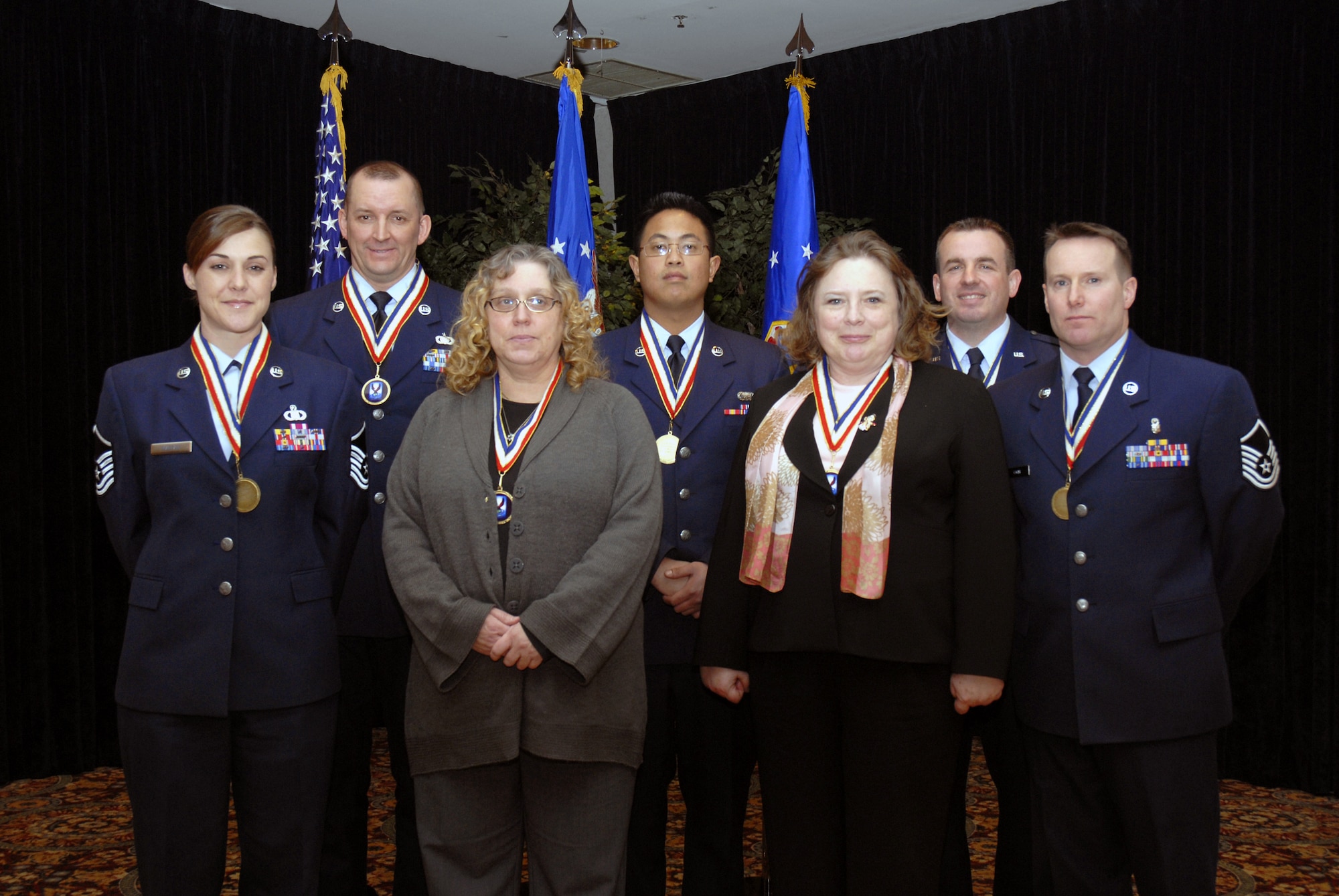 Seven of the 10 U.S. Air Force Expeditionary Center annual award winners are recognized in this photo taken on Feb. 5, 2009, in the McGuire Air Force Base, N.J., Club. They include: (from left) Master Sgt. Jennifer Mastan, Tech. Sgt. Scott Sturkol, Ms. Sandy Lewis, Airman 1st Class George Son, Mrs. Patricia Burke, Capt. Todd Caskey, and Master Sgt. Joseph Coyle.  Missing from the photo are: Mr. James Coats, Staff Sgt. Eric Brewster,  and Master Sgt. Timothy Wasut. (U.S. Air Force Photo/Staff Sgt. Paul R. Evans)
