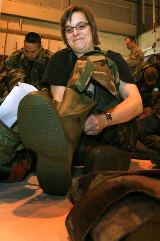 GRISSOM AIR RESERVE BASE, Ind., -- Tech. Sgt. Nancy Johnson, 434th Aerospace Medicine Squadron, does her best to slip on protective over-boots during chemical, biological, radiation, and nuclear training held during a recent unit training assembly. (U.S. Air Force photo/Tech. Sgt. Patrick Kuminecz)