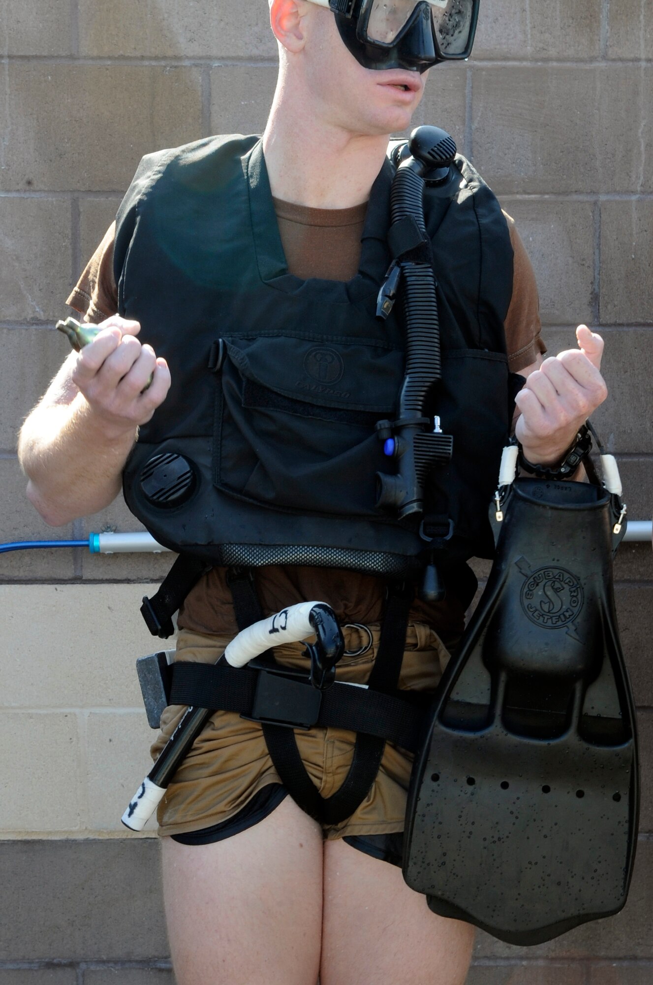 A special operations Airmen in training waits to be inspected Feb. 10 during their pre-scuba formal training at Hurlburt Field, Fla. Instructors make sure their gear is placed in the proper place for safety precautions. Airmen are assigned to the Special Tactics Training Squadron. (U.S. Air Force photo/Staff Sgt. Desiree N. Palacios)