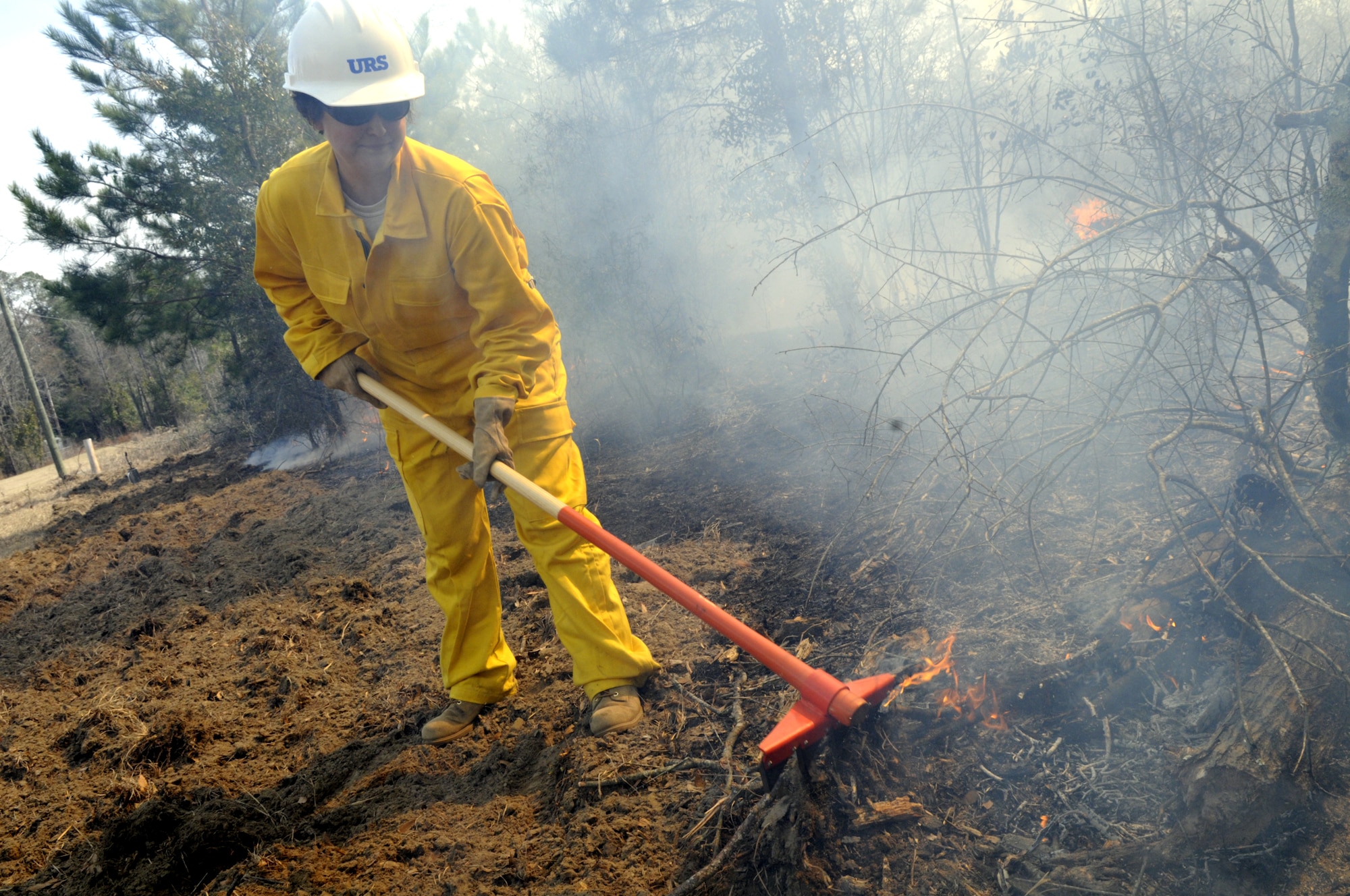 Marilyn Rodgers , an environmental scientist with the 78th Civil Engineer Group, labors to keep the controlled burn in check. U. S. Air Force photo by Sue Sapp  