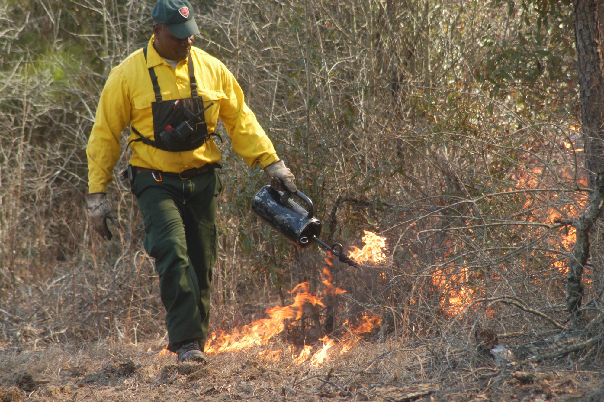 Willie Vance,  Georgia Forestry commission  ranger for Peach and Houston counties, lights some underbrush on fire during the controlled burn of a long-leaf pine forest on the south end of the base Feb. 9. U. S. Air Force photo by Sue Sapp   