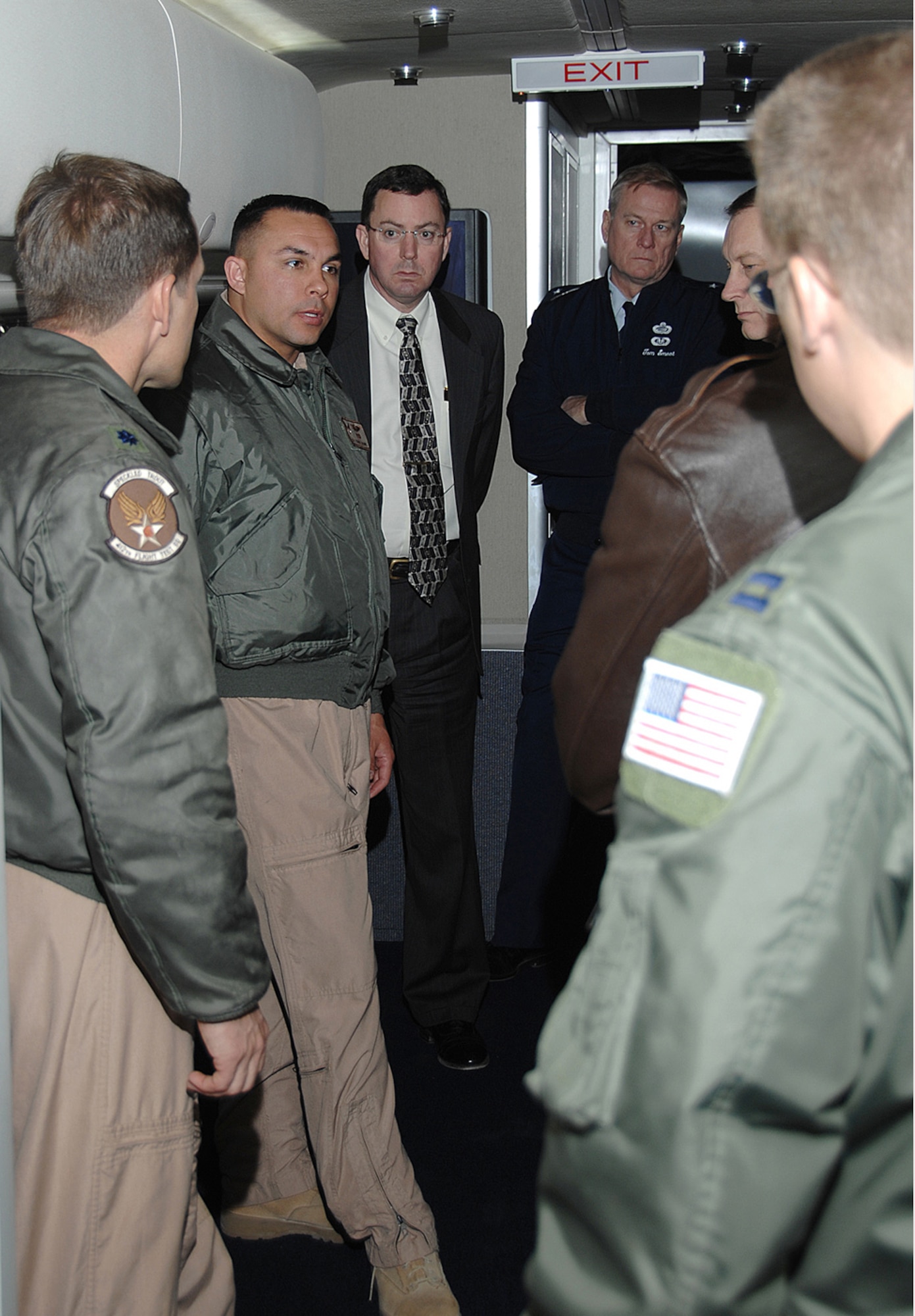 Staff Sgt. Dan Wowk, communications system operator with the 412th Flight Test Squadron at Edwards Air Force Base, explains communications test capabilities of the Test Tanker II aircraft to Air Force Materiel Command senior leaders.  Lt. Col. Jordan Kriss, 412th FLTS commander (left), Dr. Steve Butler, AFMC Executive Director and Brig Gen. Tom Smoot, AFMC Director of Personnel, listen in.  The Test Tanker II, a modified KC-135 in service with the Air Force Flight Test Center, visited Wright-Patterson Feb. 6.  (U.S. Air Force photo/Ben Strasser)