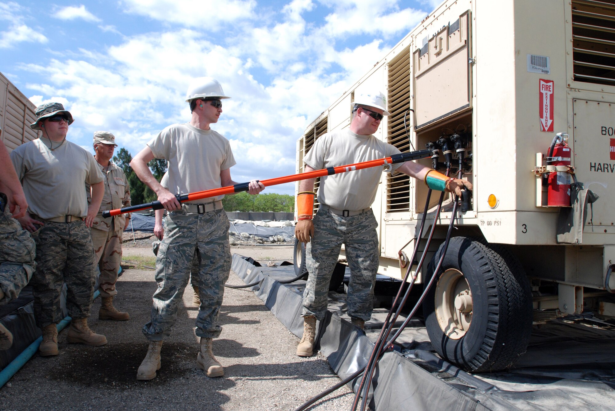 Senior Airman Nathan Ansell and Master Sgt. Daryl Smith learn how to make repairs on generators, Feb. 3. Both Air National Guardsmen are assigned to the 130th Airlift Wing, Civil Engineering Squadron, and are currently being trained to join the 474th Expeditionary Civil Engineering Squadron, which maintains Joint Task Force Guantanamo’s Camp Justice and Expeditionary Legal Complex. JTF Guantanamo conducts safe, humane, legal and transparent care and custody of detained enemy combatants, including those convicted by military commission and those ordered released. The JTF conducts intelligence collection, analysis and dissemination for the protection of detainees and personnel working in JTF Guantanamo facilities and in support of the Global War on Terror. JTF Guantanamo provides support to the Office of Military Commissions, to law enforcement and to war crimes investigations. The JTF conducts planning for and, on order, responds to Caribbean mass migration operations. 



