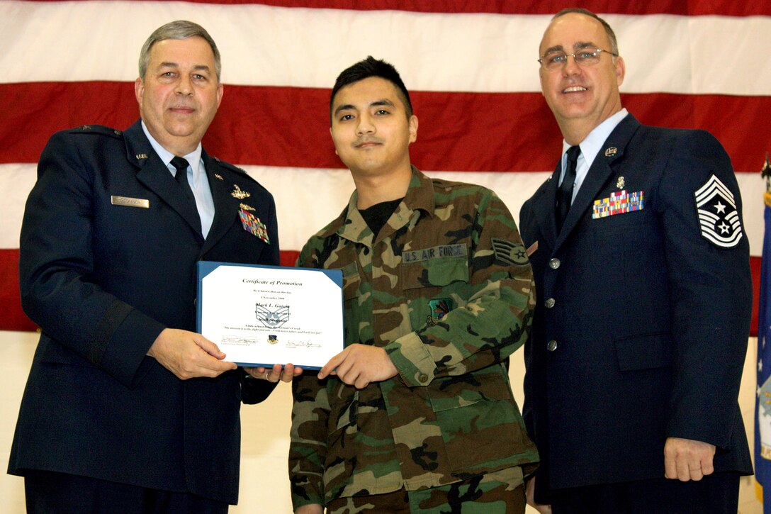 GRISSOM AIR RESERVE BASE, Ind., -- Brig. Gen. Dean Despinoy, 434th Air Refueling Wing commander, left, presents Staff Sgt. Mark Garcia, a supply management apprentice with the 434th Logistics Readiness Squadron, with a certificate recognizing his promotion to staff sergeant. Joining the two is Chief Master Sgt. Larry Brady, 434th ARW command chief. (U.S. Air Force photo/Tech. Sgt. Patrick Kuminecz)