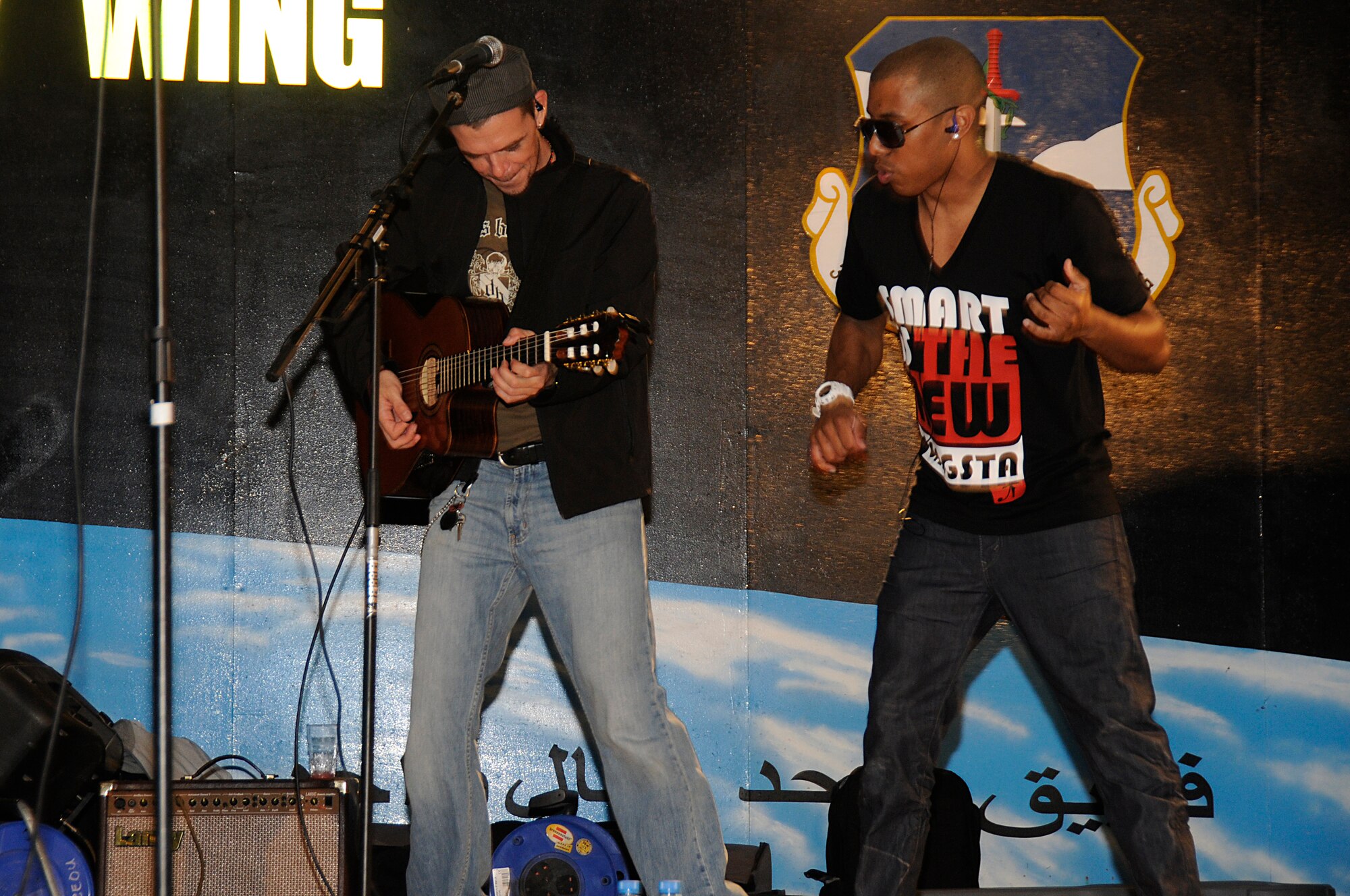 SOUTHWEST ASIA - Los Bad Apple member Zeale, emcee rocks out with Greg "Doctor" Jones during their performance for Airmen at the 380th Air Expeditionary Wing, Feb 10. Los Bad Apples are a latin inspired hip-hop band on their second stop of an Armed Forces Entertainment tour. (U.S. Air Force photo by Senior Airman Brian J. Ellis) (Released)