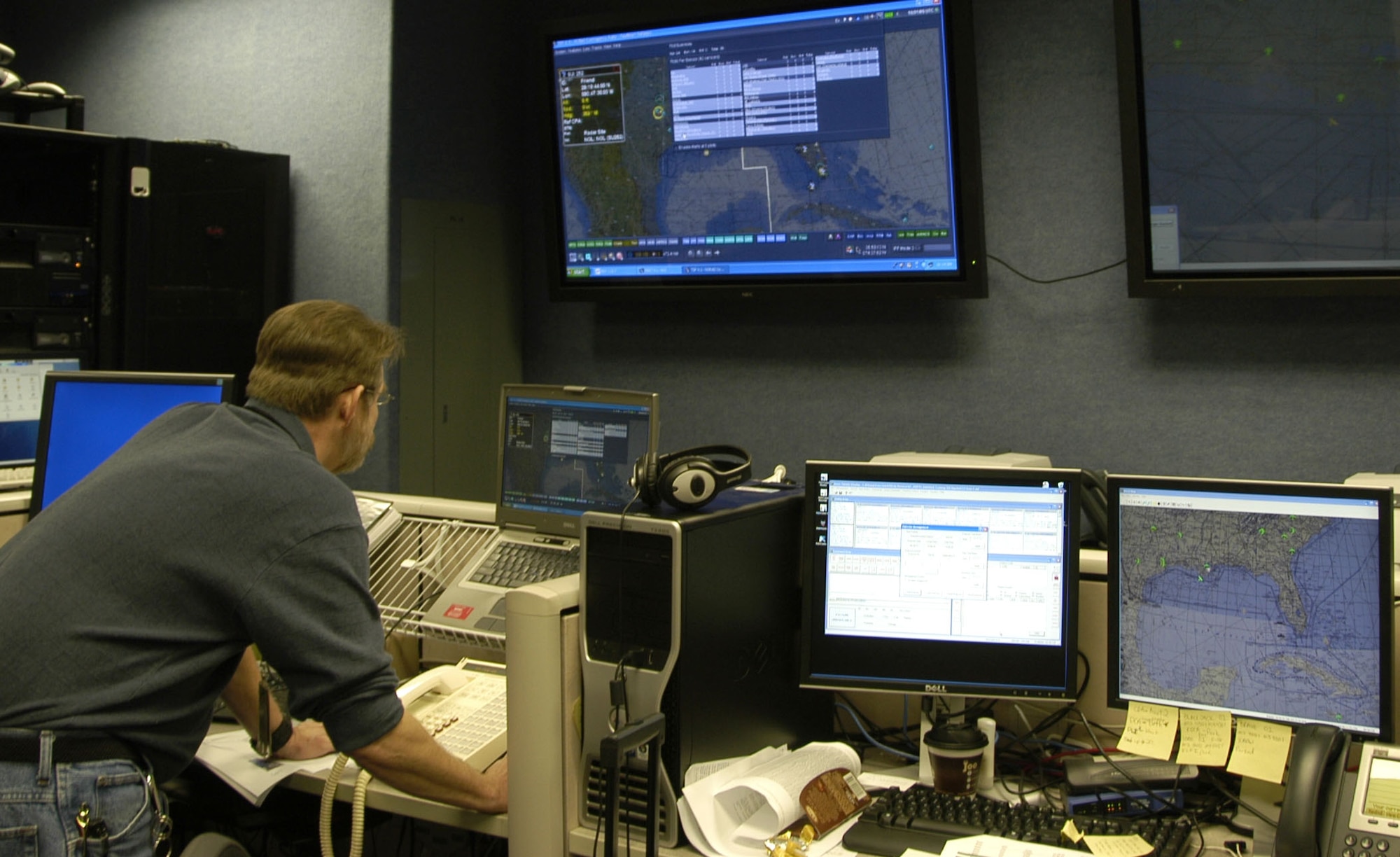 Dwight Herndon, an ARINC computer network and systems analyst, sets up a training mission using distributed mission operations technology. Photo by Ms Mary McHale