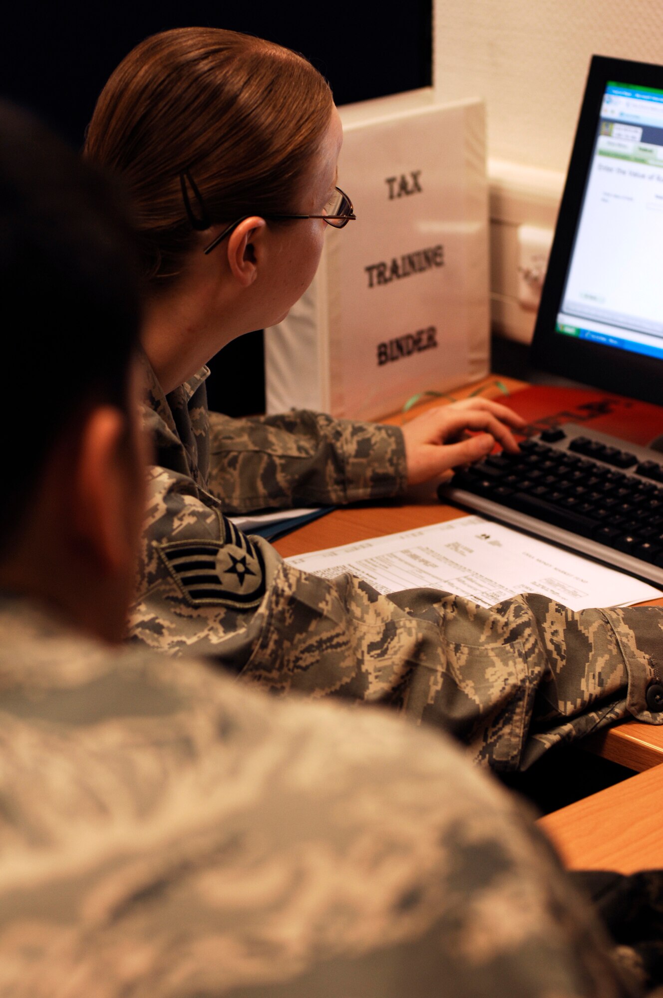 Staff Sgts. Sean Sawyer (left) and Katie Sawyer, 1st Combat Communication Squadron members, do their taxes at the tax center located in the legal office Feb. 10, 2009, at Ramstein Air Base. The tax center is open from June 15, 2009, and helps about 2,500 customers complete their taxes. (U.S. Air Force photo by Senior Airman Amber Bressler)
