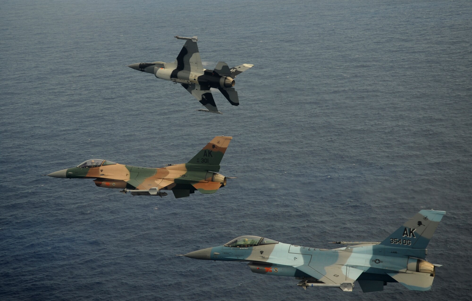 A 3-ship of F-16 Fighting Falcons, 18th Aggressor Squadron, Eielson Air Force Base, Alaska, fly over the Pacific Ocean during exercise Cope North 09-1, Feb. 10. Units from the U.S. Air Force, U.S. Navy, and the Japan Air Self Defense Force are participating in exercise Cope North at Andersen AFB, Guam from 2-13 Feb.  Cope North 09-1 is the first iteration of a regularly scheduled joint and bilateral exercise and is part of the on-going series of exercises designed to enhance air operations in defense of Japan.(U.S. Air Force photo/ Master Sgt. Kevin J. Gruenwald) released      