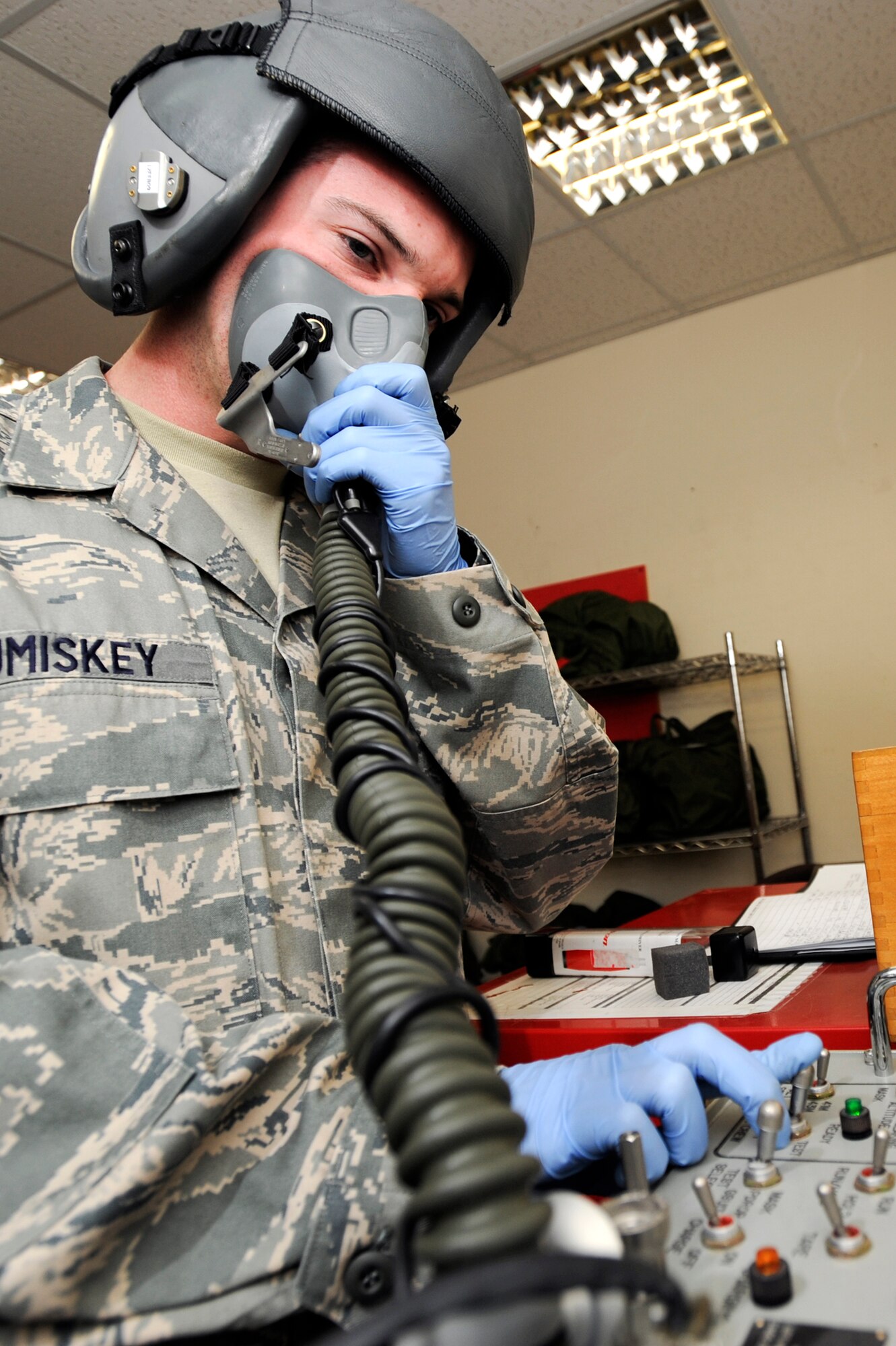 Senior Airman John Cumiskey, an aircrew flight equipment technician with the 379th Expeditionary Operations Support Squadron, checks an MBU 12/P Mask with an oxygen mask test unit for serviceability, Feb. 10, 2009, in an undisclosed location in Southwest Asia.  The test unit ensures oxygen will flow properly to the crew member and the seal on the mask is good. Airman Cumiskey is native to Fairfield, Conn. and deployed from Offutt Air Force Base, Neb. in support of Operations Iraqi and Enduring Freedom and Combined Joint Task Force - Horn of Africa. (U.S. Air Force Photo by Staff Sgt. Joshua Garcia/released)